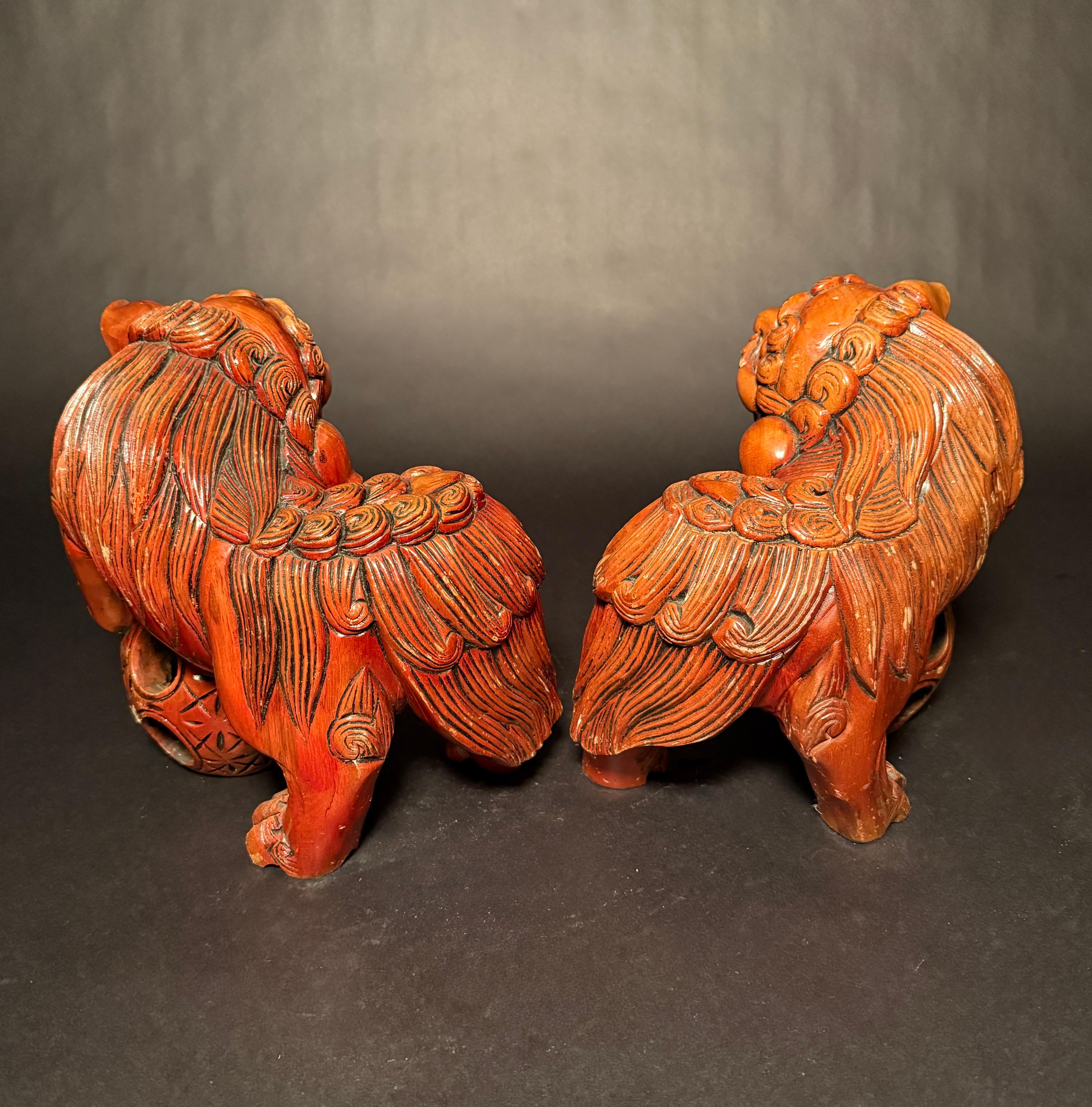Chinese Export Pair Chinese Carved Hardwood Foo dogs with Rolling Pearls & Puzzle Balls For Sale