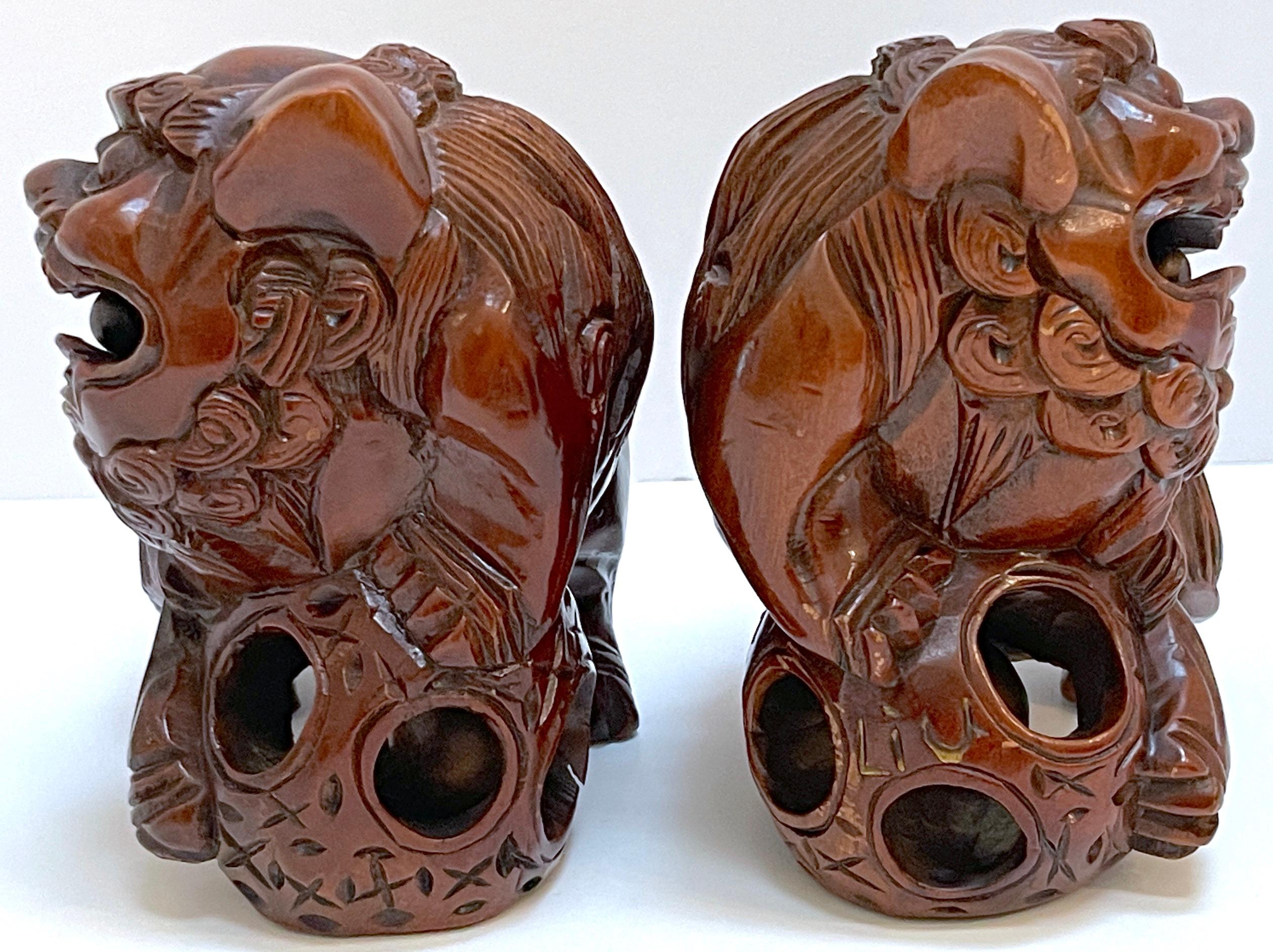 20th Century Pair Chinese Carved Hardwood Foo dogs with Rolling Pearls & Puzzle Balls  For Sale