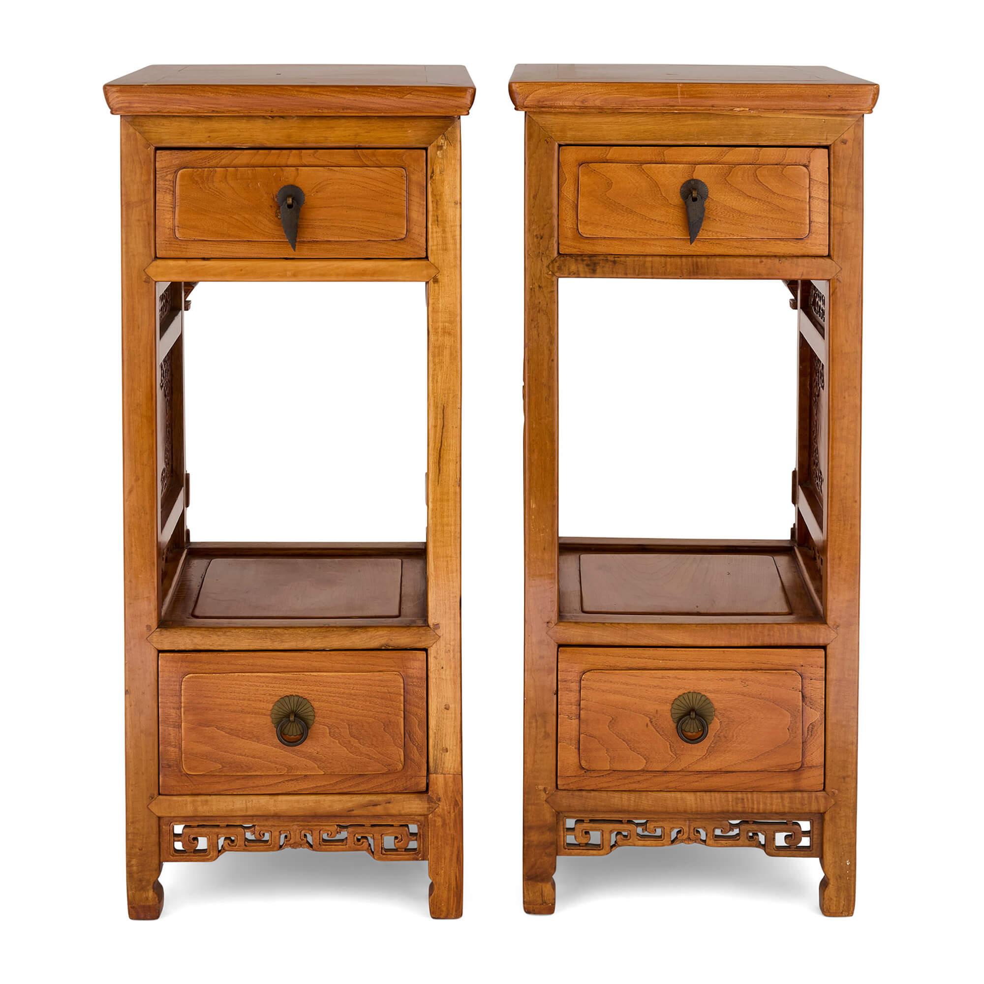 Pair Chinese Carved Hardwood Metal Pedestals Stands Tables 
Chinese, 20th Century 
Height 97cm, width 40cm, depth 49cm

This distinctive pair of Chinese pedestals, dating to the 20th century, showcases superb craftsmanship with intricately carved