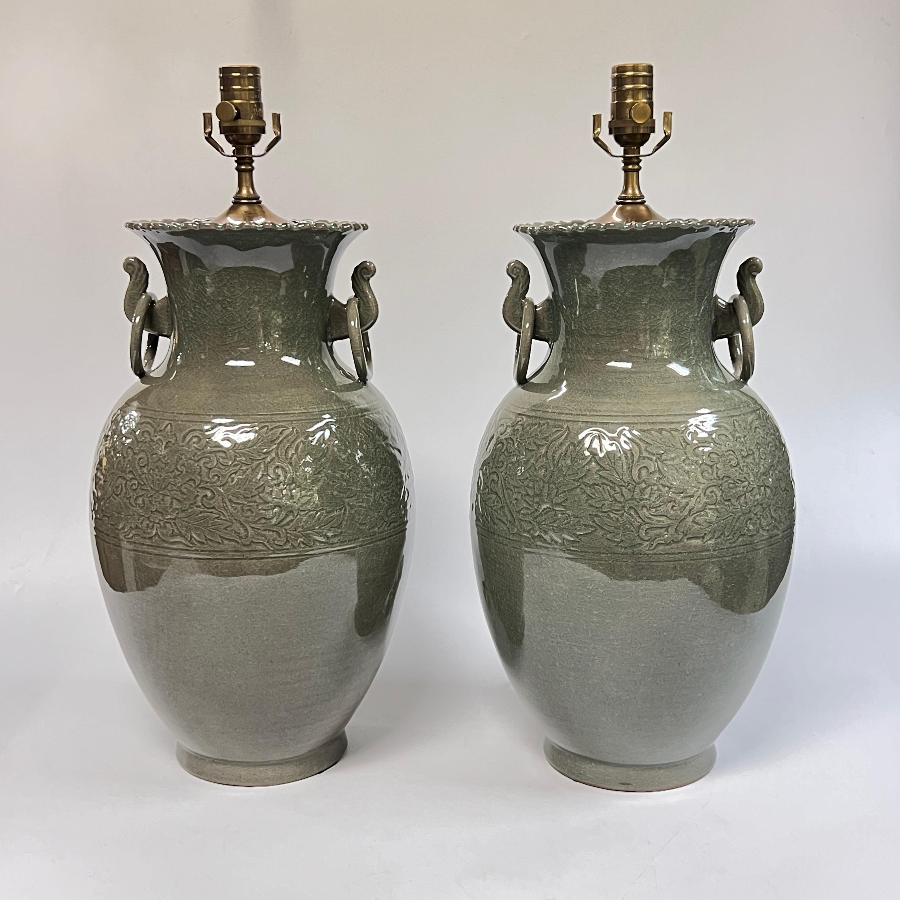 Paire de lampes de table vintage fabriquées à partir de vases en céramique chinoise avec une bande de motifs organiques incisés, un col pincé avec des poignées en forme d'anneau et une glaçure craquelée. 