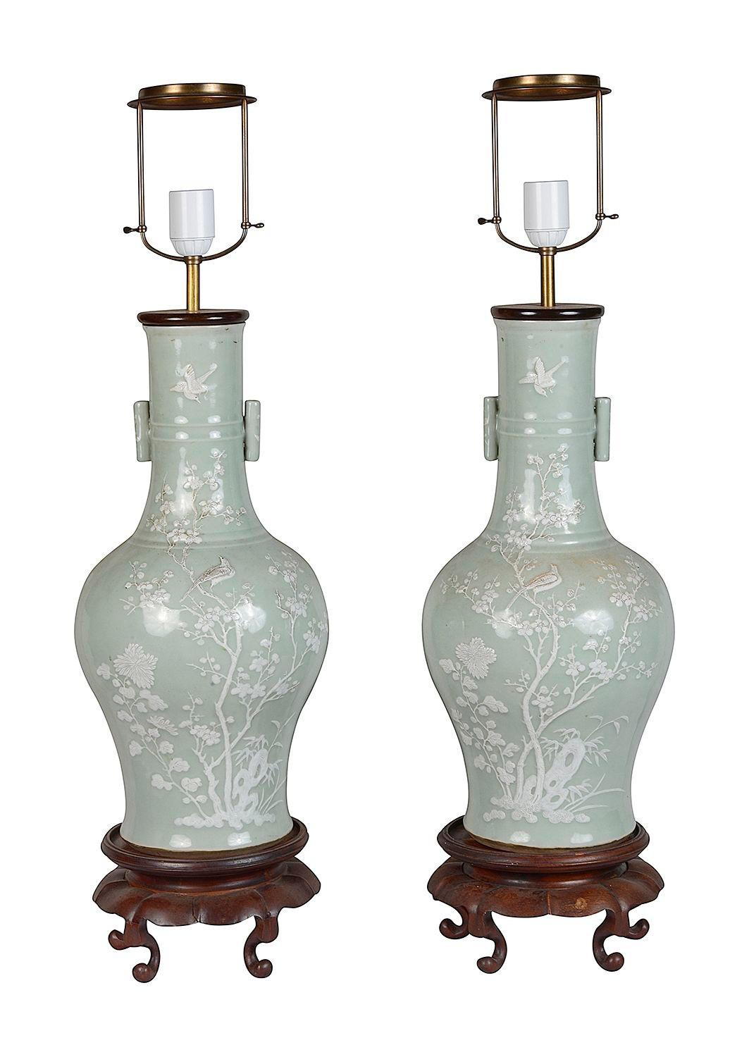 A very impressive and decorative pair of late 19th Century Chinese Celadon porcelain vases / lamps. Each with wonderful raised floral and folate decoration with birds perched on the branches. Raised on classical carved hardwood stands.


Batch 76 N/H
