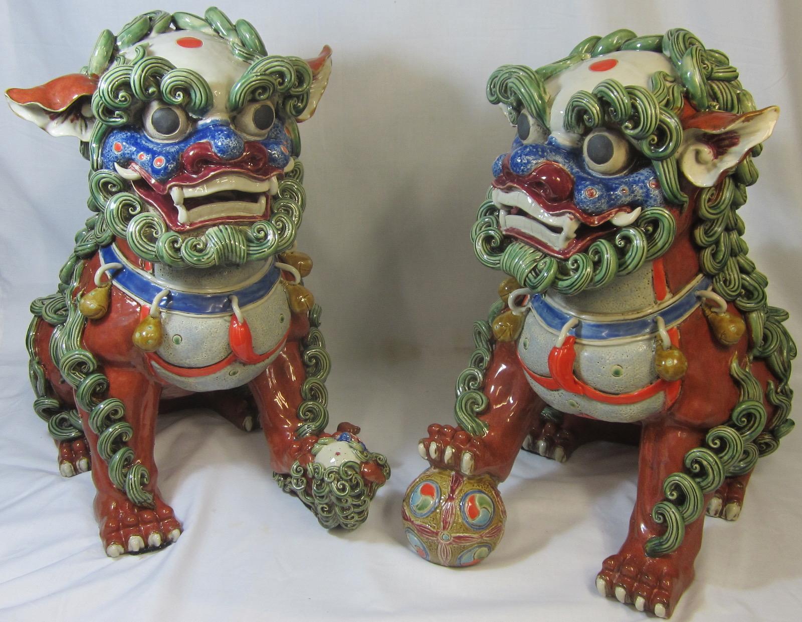 Pair Chinese ceramic foo dogs, 
decorated in brilliant overglaze enamels. 
Measures: Weight 20kg (44 pounds) each. 
 
