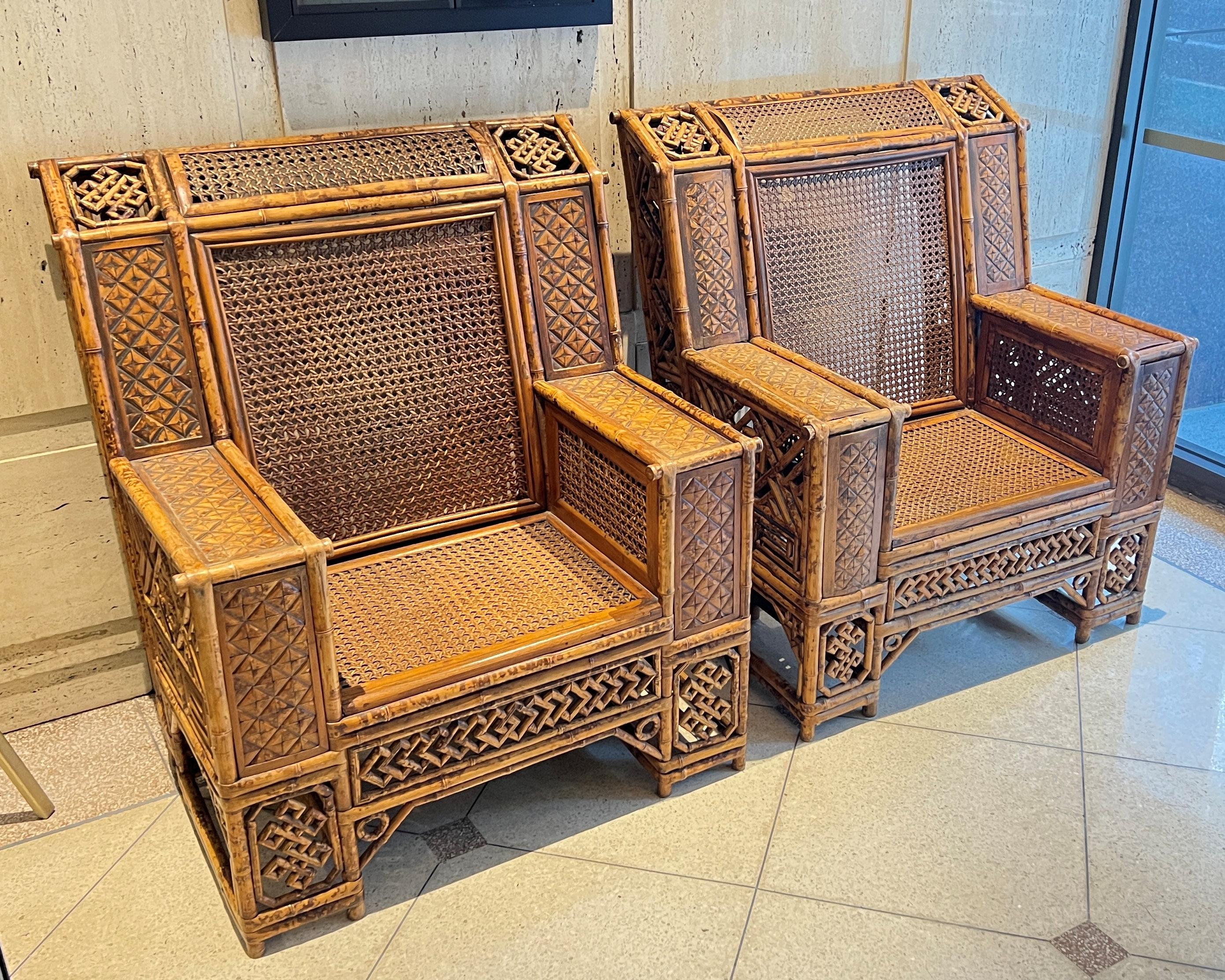 Our pair of armchairs, inspired by the Royal Pavilion style of the Georgian (George III reign) period, feature open fretwork panels and frames crafted from bamboo with rattan seats and seatbacks. Each in very good condition.