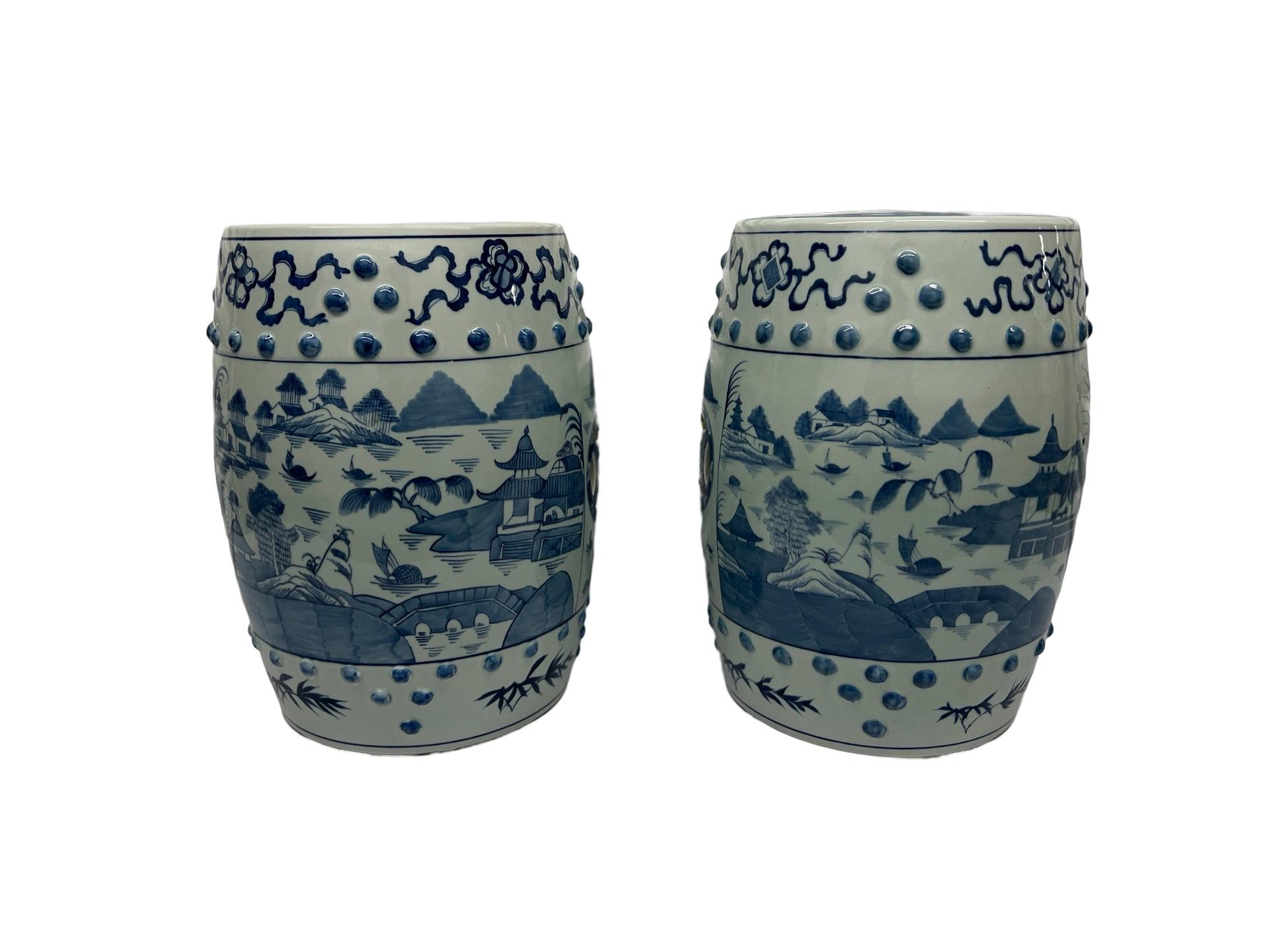 Chinese, 20th century.

A pair of Chinese export style porcelain garden stools. Each stool is decorated in blue and white underglaze porcelain with Traditional Canton pagoda scenes, pierced areas to each side and tops. Ribbons surrounding precious