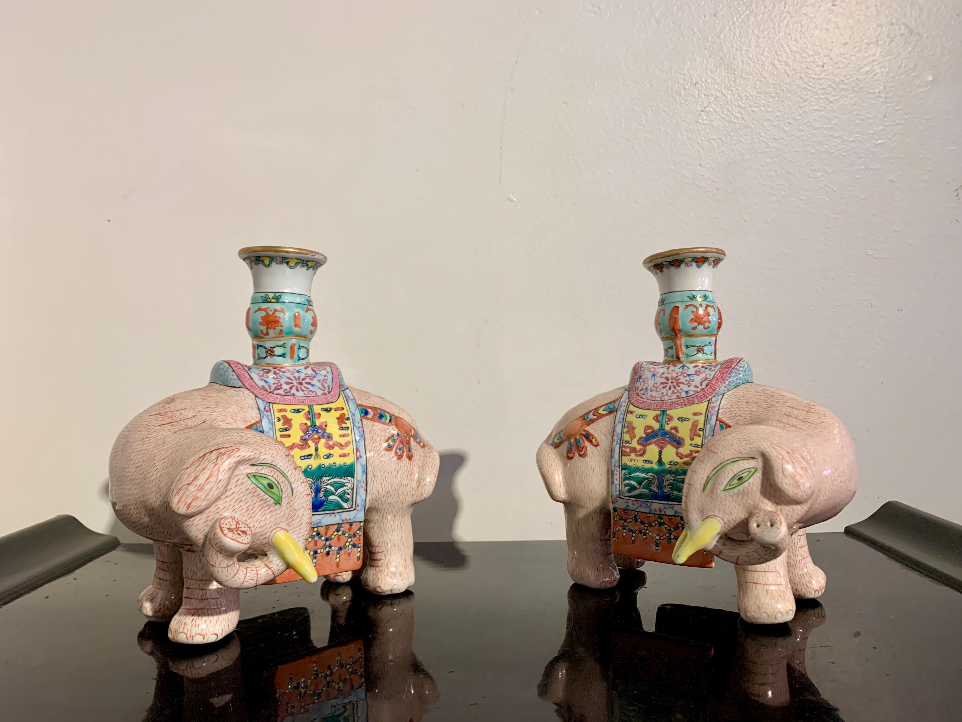 A delightful pair of Chinese export famille rose enameled porcelain candle holders, late Qing Dynasty or early Republic Period, early 20th century, China.

The whimsical pair of candleholders each formed as a sturdy elephants standing foursquare,