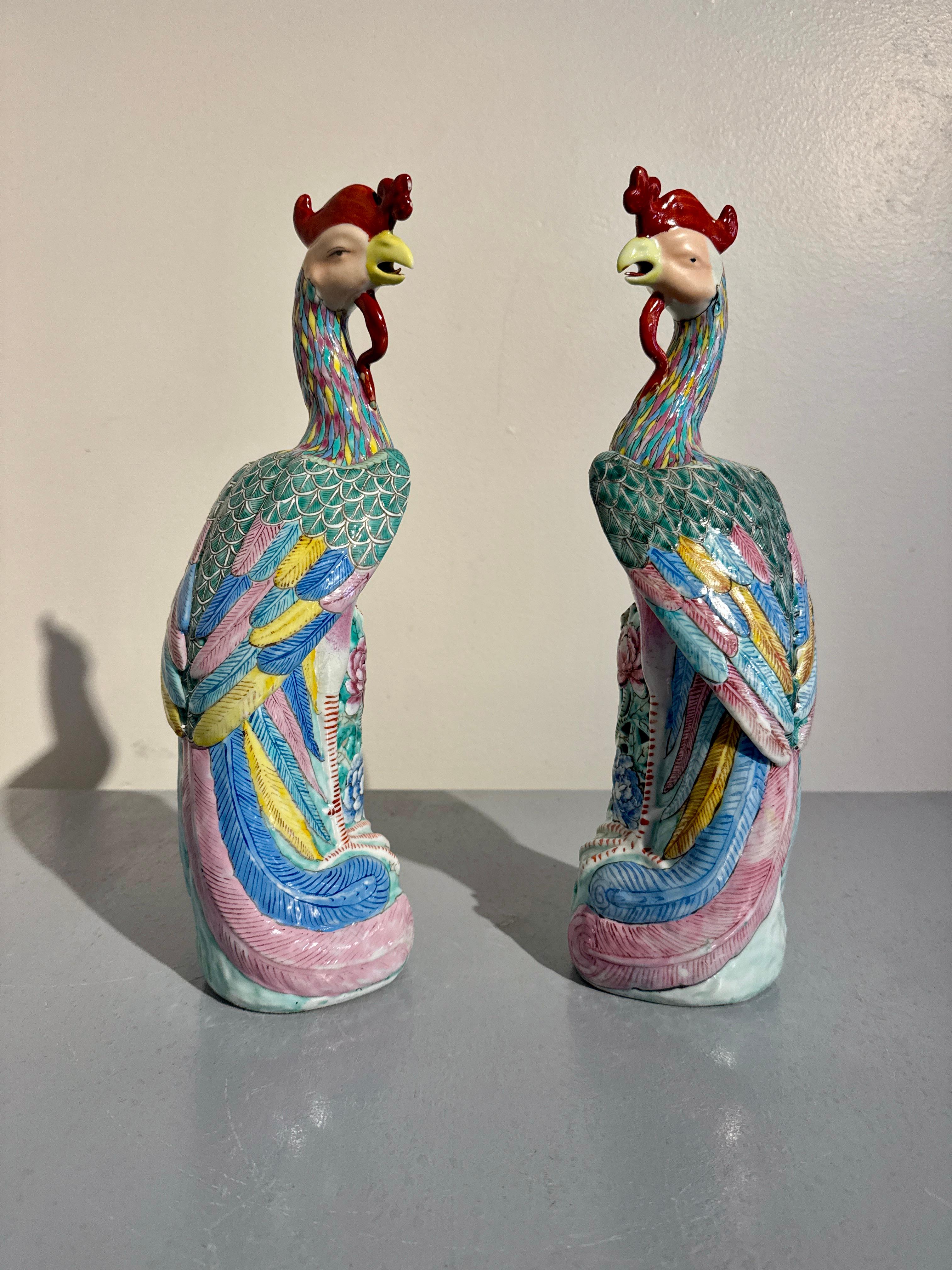A gorgeous pair of Chinese export famille rose enameled porcelain models of phoenixes, marked Jin Sheng Cheng, Republic Period (1911 - 1949), mid 20th century, China.

The noble birds perch demurely upon openwork rocky bases populated by large