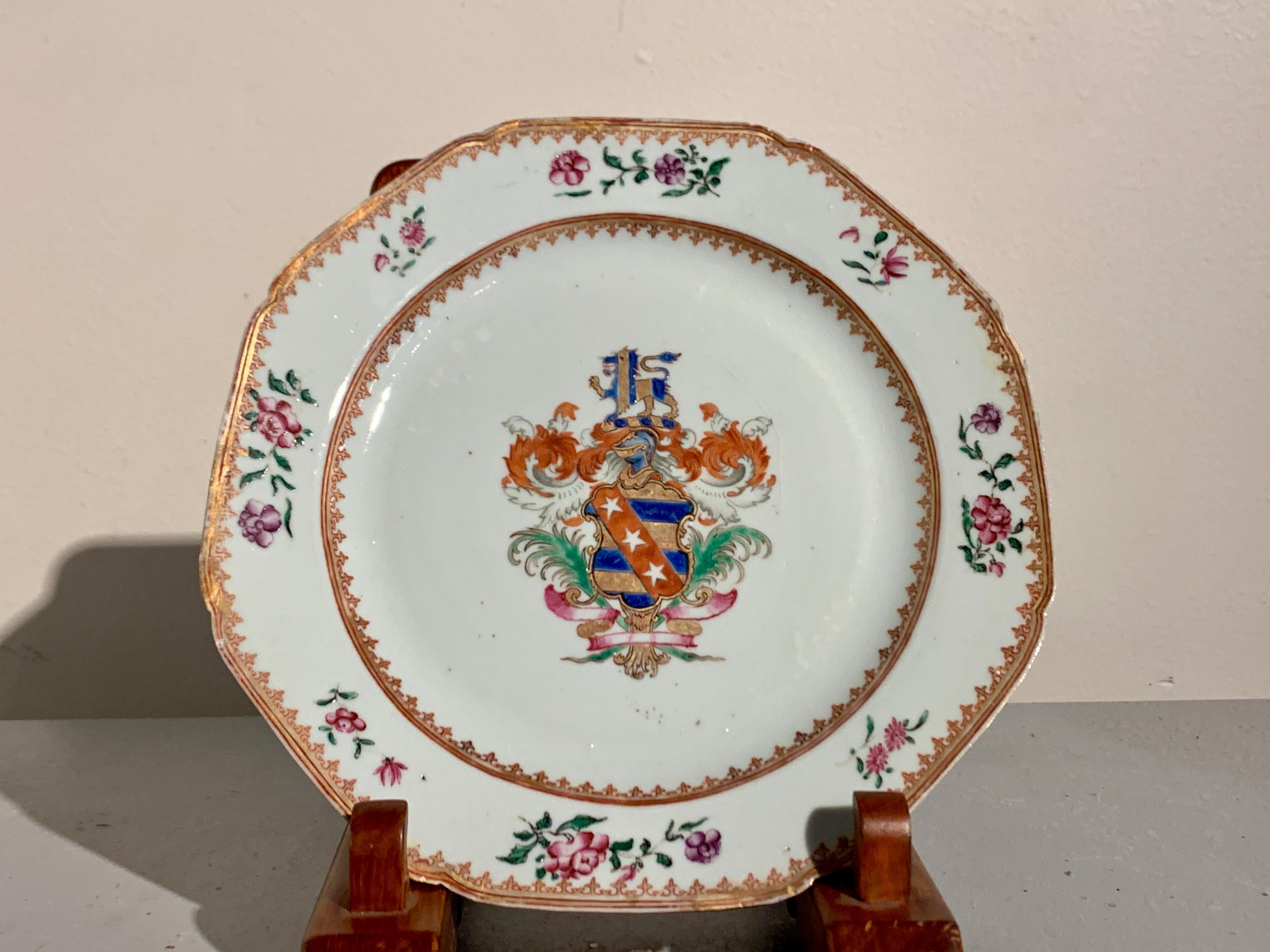 A lovely pair of Chinese export famille rose enameled porcelain armorial plates, mid 18th century, China.

The plates of unusual octagonal form with scalloped corners. The center of each dish painted with a large armorial design based on the
