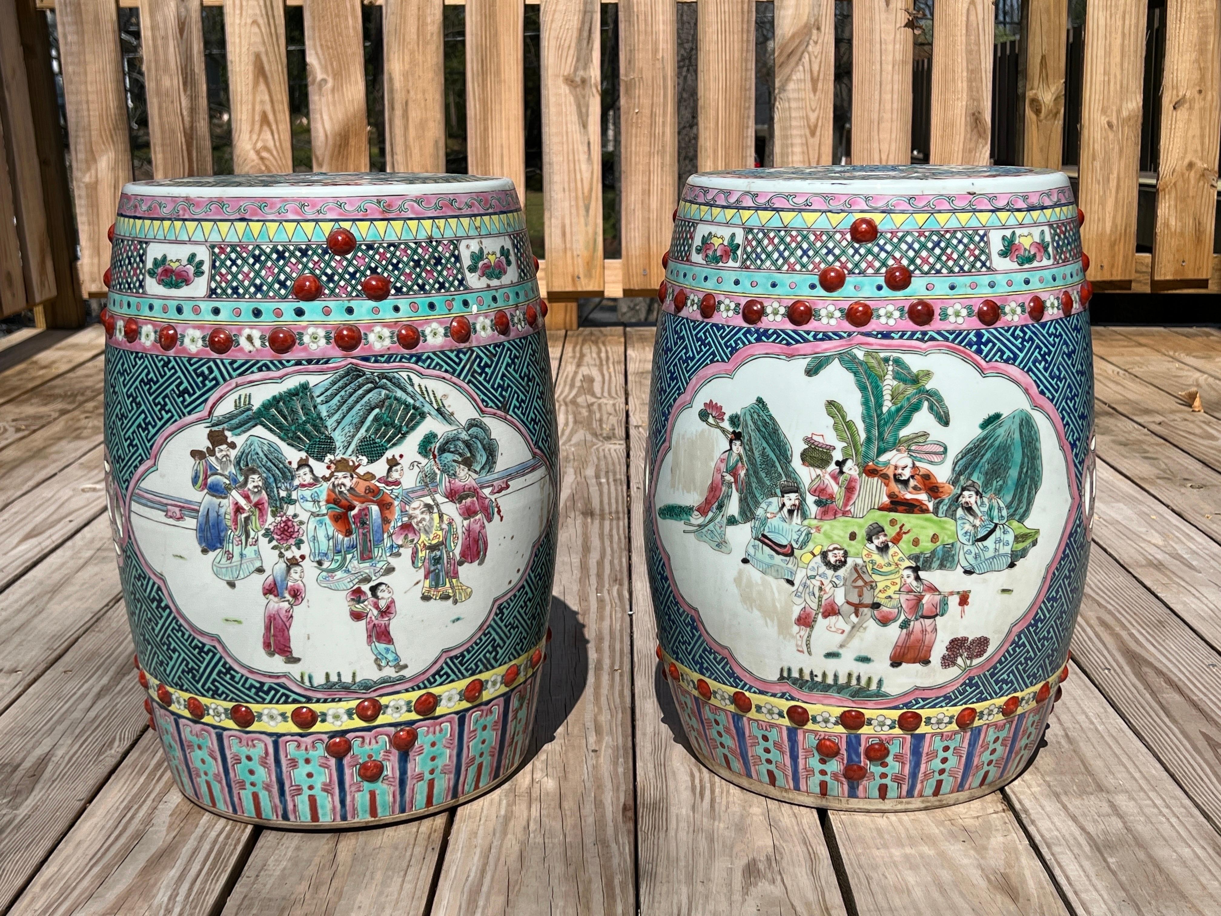 Chinese, early to mid 20th century.

A pair of likely mid century Chinese porcelain garden stools. Each stool features enamel decorated surfaces of figural windows, landscapes and precious objects. 
A Famille Rose motif exudes an array of colors to