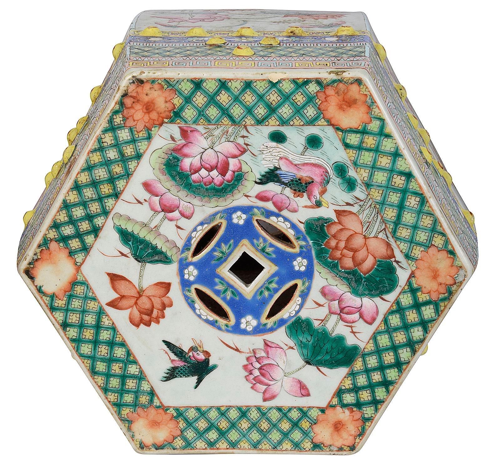 A very good quality pair of late 19th Century Chinese famille Rose octagonal porcelain Garden Seats, each with wonderful bold colours, with classical motif boarders top and bottom, the central hand painted panels depicting exotic flower, pierced