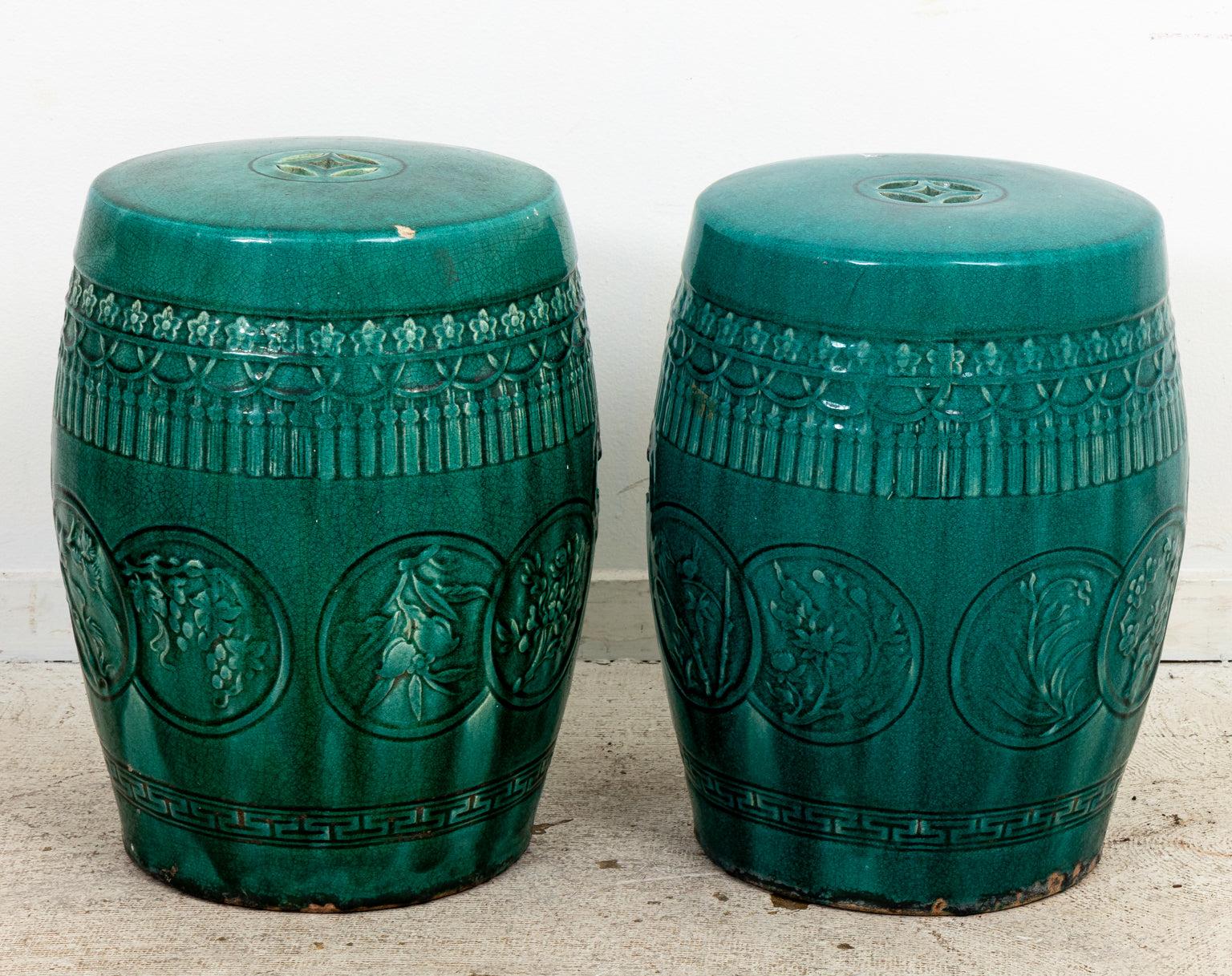 Pair green glazed garden stools with pierced bat form handles. Wear consistent with age.