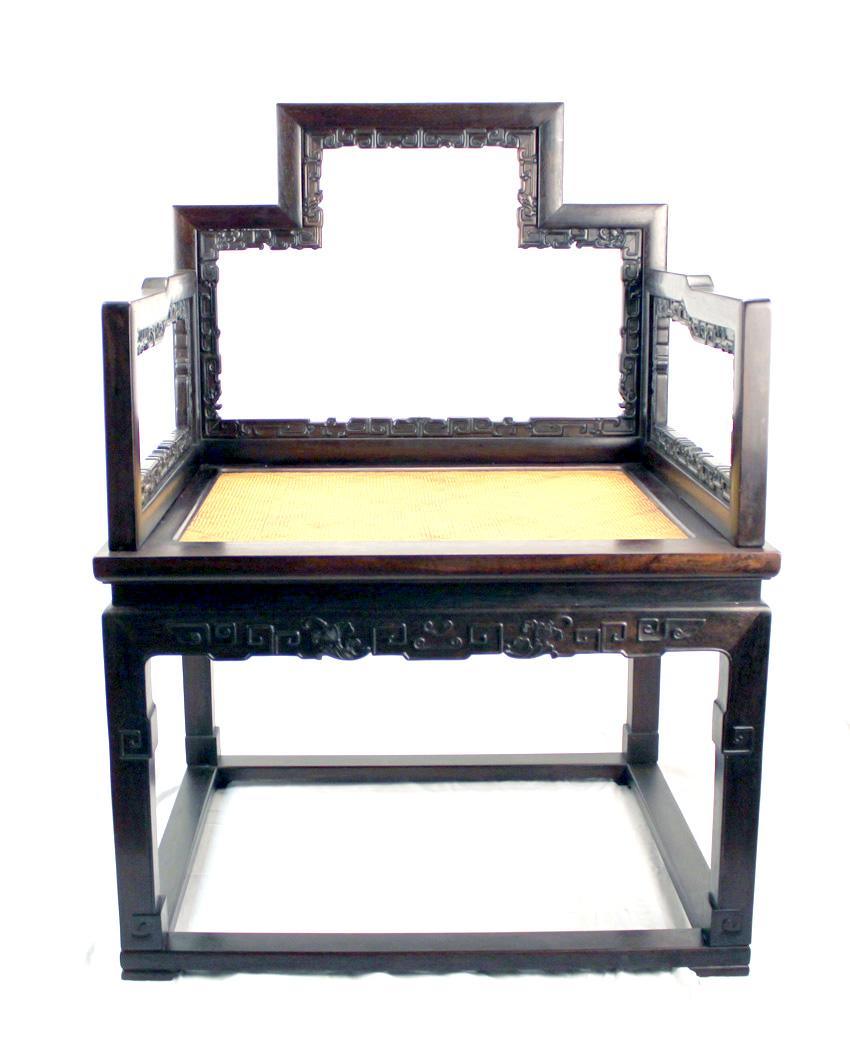 We are proud to offer this pair of amazing Chinese solid zitan carved low back chairs. They have detail carving around their body. The back support and arm rests are lightly carved with chi' long, a form of Chinese dragon. This pair is made entirely