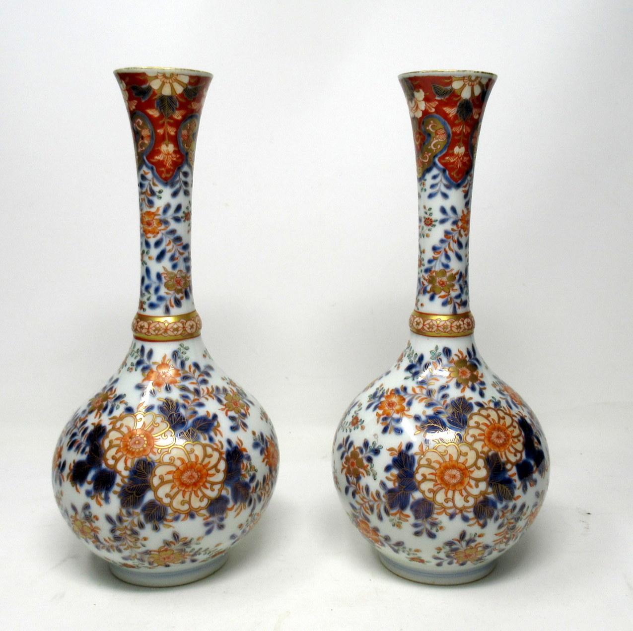 Stunning pair of Chinese or Japanese Imari bottle vases of compact size, made during the last quarter of the 19th century.

The tall elegant slender circular necks with gently flaring rims above a bulbous circular body on ring support bases. Hand