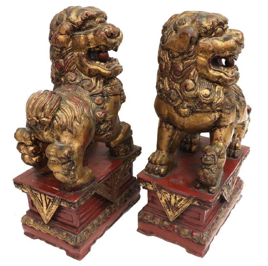 Lacquered Pair of Chinese Parcel-Gilt Red Foo Lions