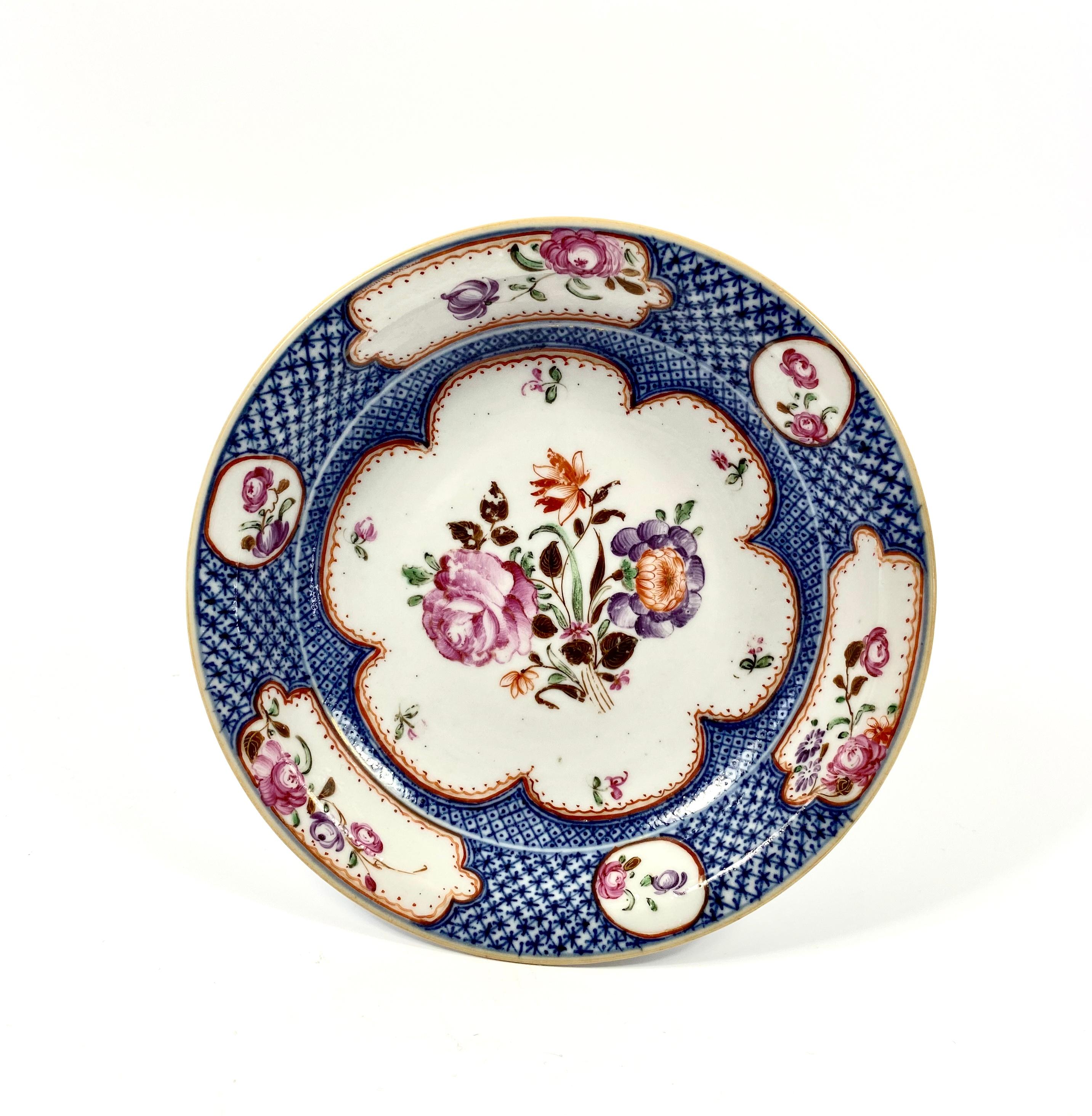 Pair of Chinese porcelain dishes, circa 1760. Qianlong Period. The ‘Compagnie des Indes’ style dishes, painted in fencai or famille rose enamels, with sprays of flowers, within a large petal shaped panel, within an underglaze blue cell diaper