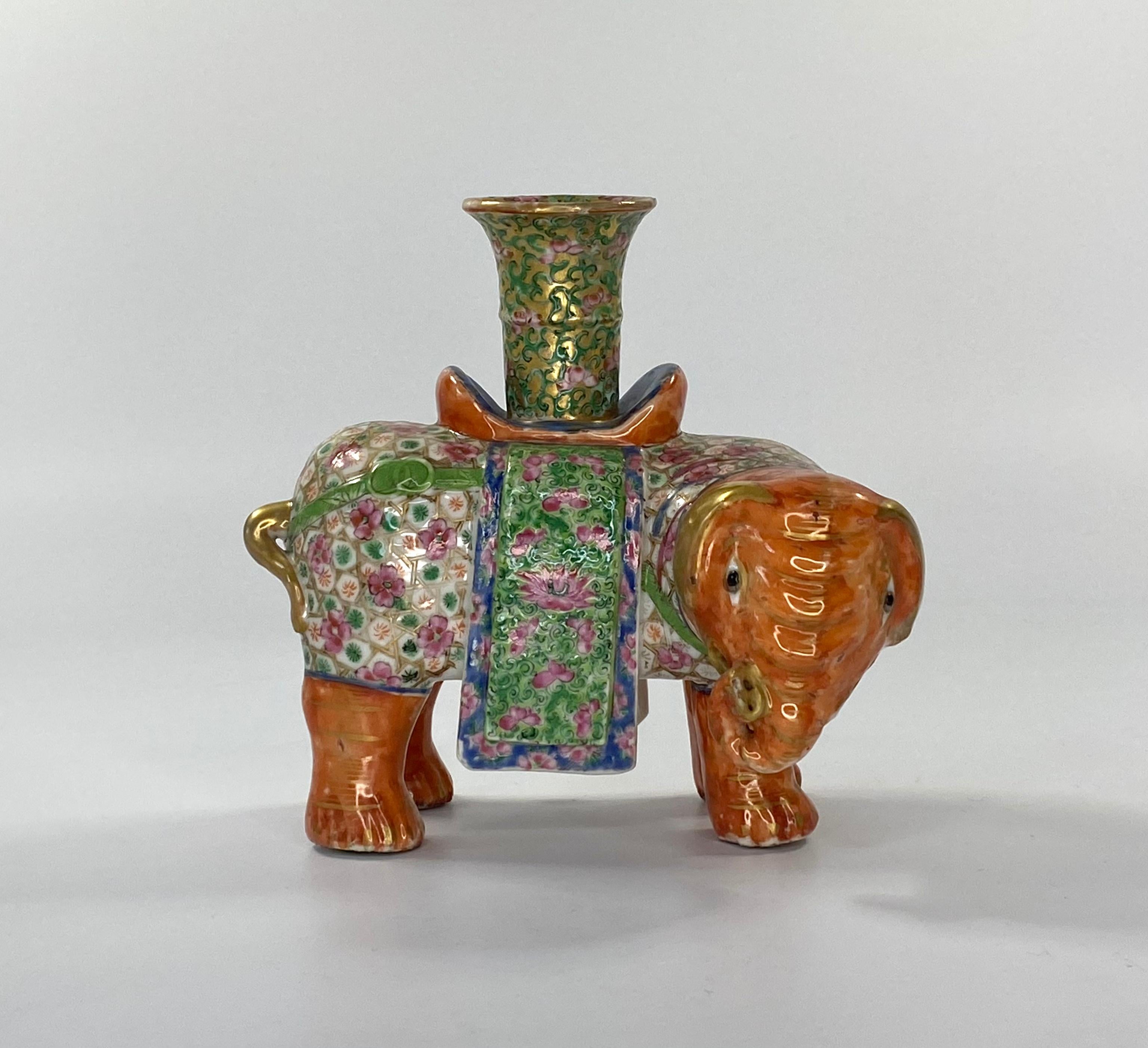 A fine pair of Chinese porcelain elephant joss stick holders, circa 1850. Both caparisoned elephants having iron red bodies, highlighted in gilt. The drapes well decorated in famille rose enamels with flowering plants weaving through a gilt trellis.