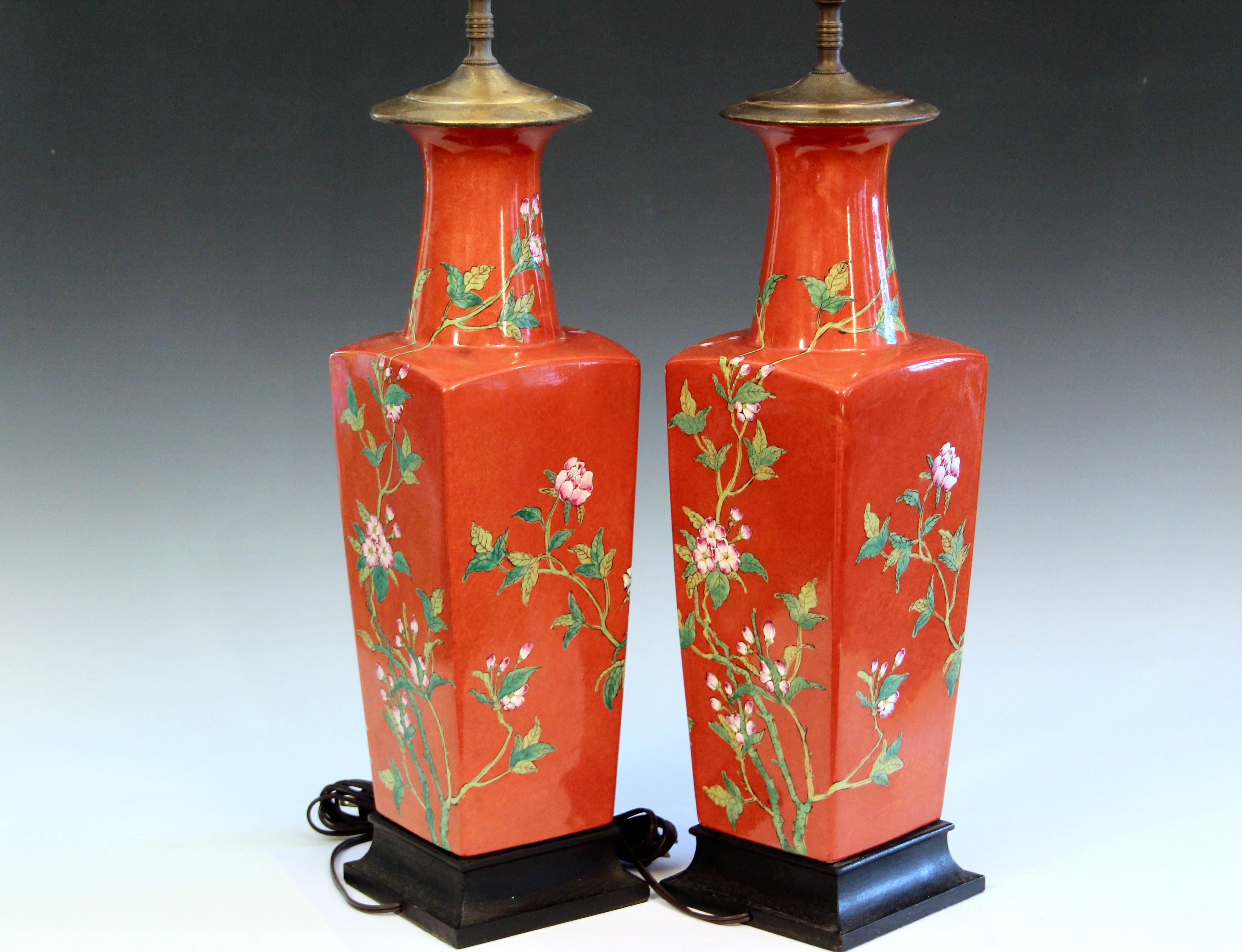 Pair vintage Chinese porcelain chinoiserie square form bottle lamps richly decorated with peonies on a cinnamon red ground, circa 1970's. Beautiful color, nice quality painting. 3-way switches. New sockets and cords. Shades not included. 36