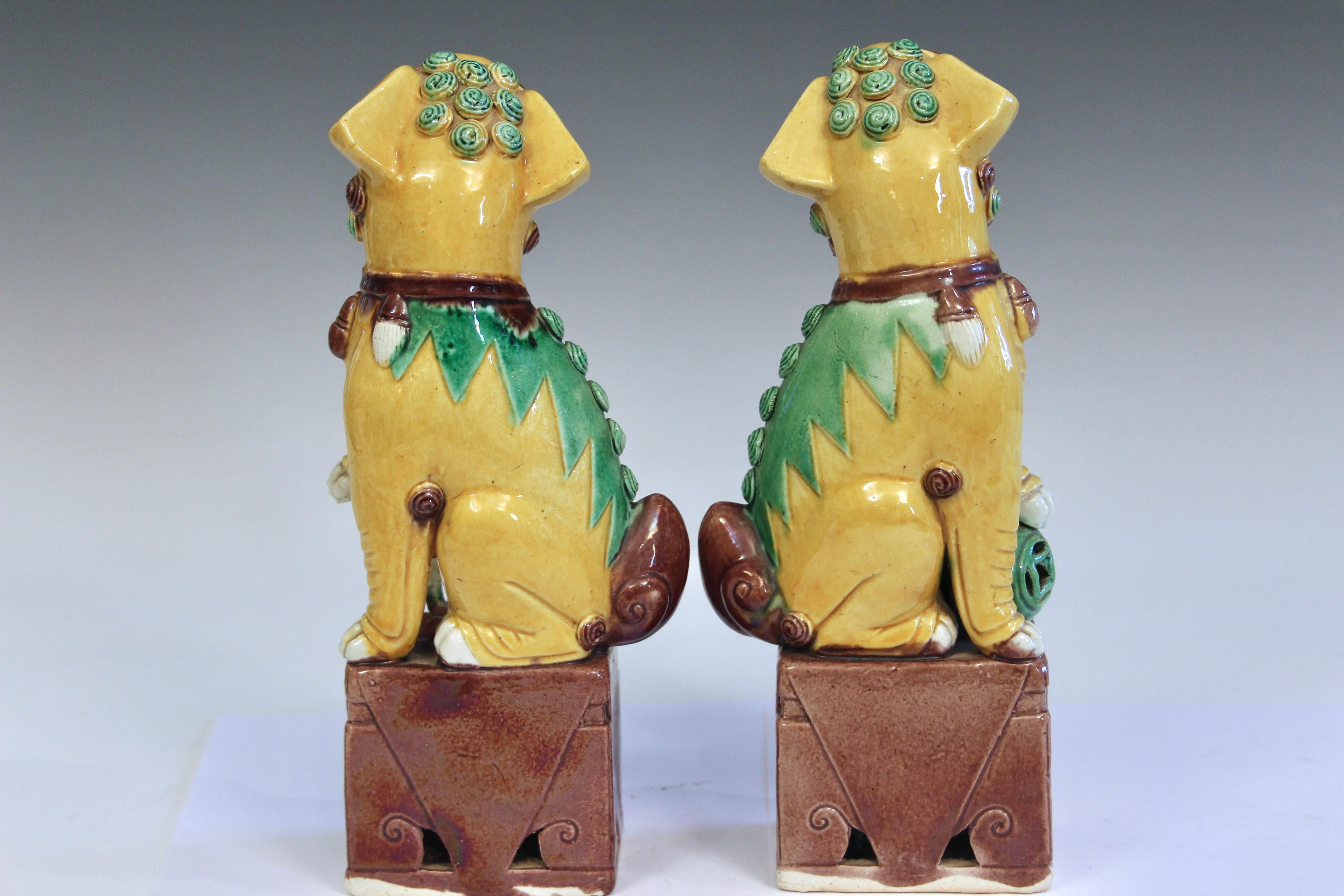Pair vintage Chinese export porcelain Kangxi style buddhist lions in three color glaze, circa 20th century. 9 3/4