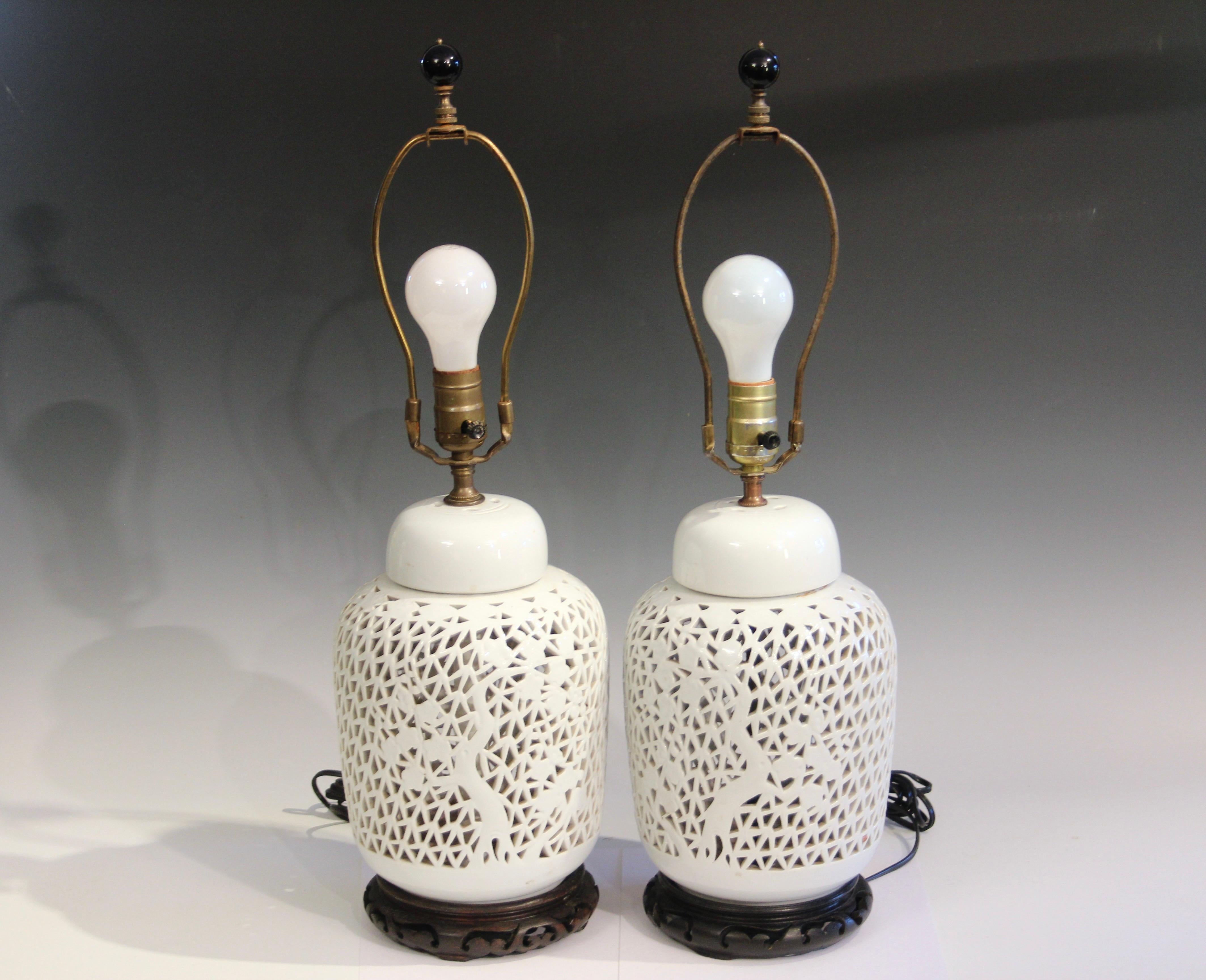 Pair old vintage Chinese porcelain reticulated white lamps, circa early/mid 20th century. Hand carved design of trees. 3-way switches. Shades not included. Excellent condition, new wiring, as shown. 25