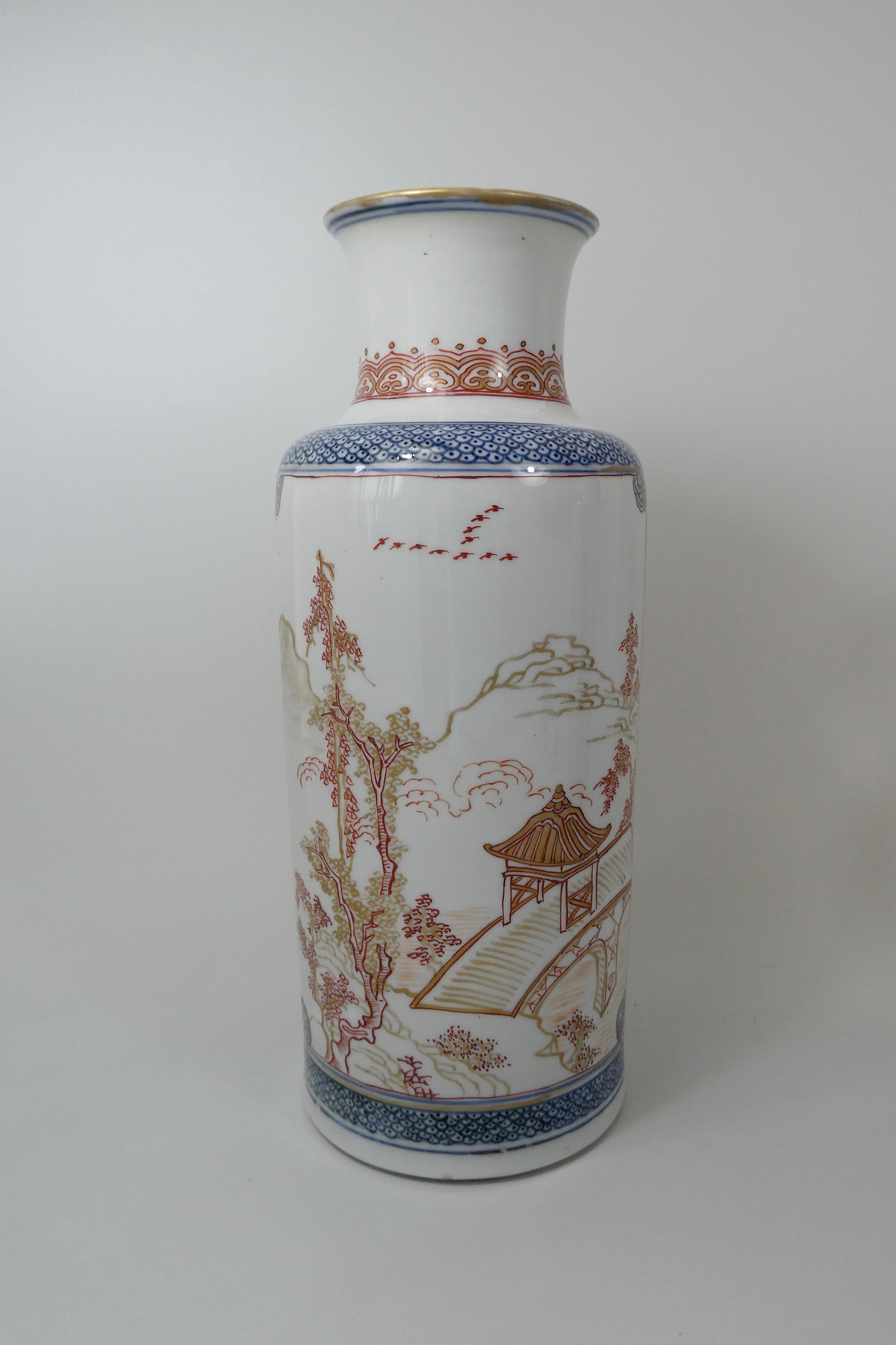 A fine pair of Chinese porcelain vases, c.1700, Kangxi Period. Both vases decorated in ‘rouge de fer’ with pavilions, bridges and trees, amongst mountainous river landscapes. The scenes enclosed within scrolled panels, upon an underglaze blue scale