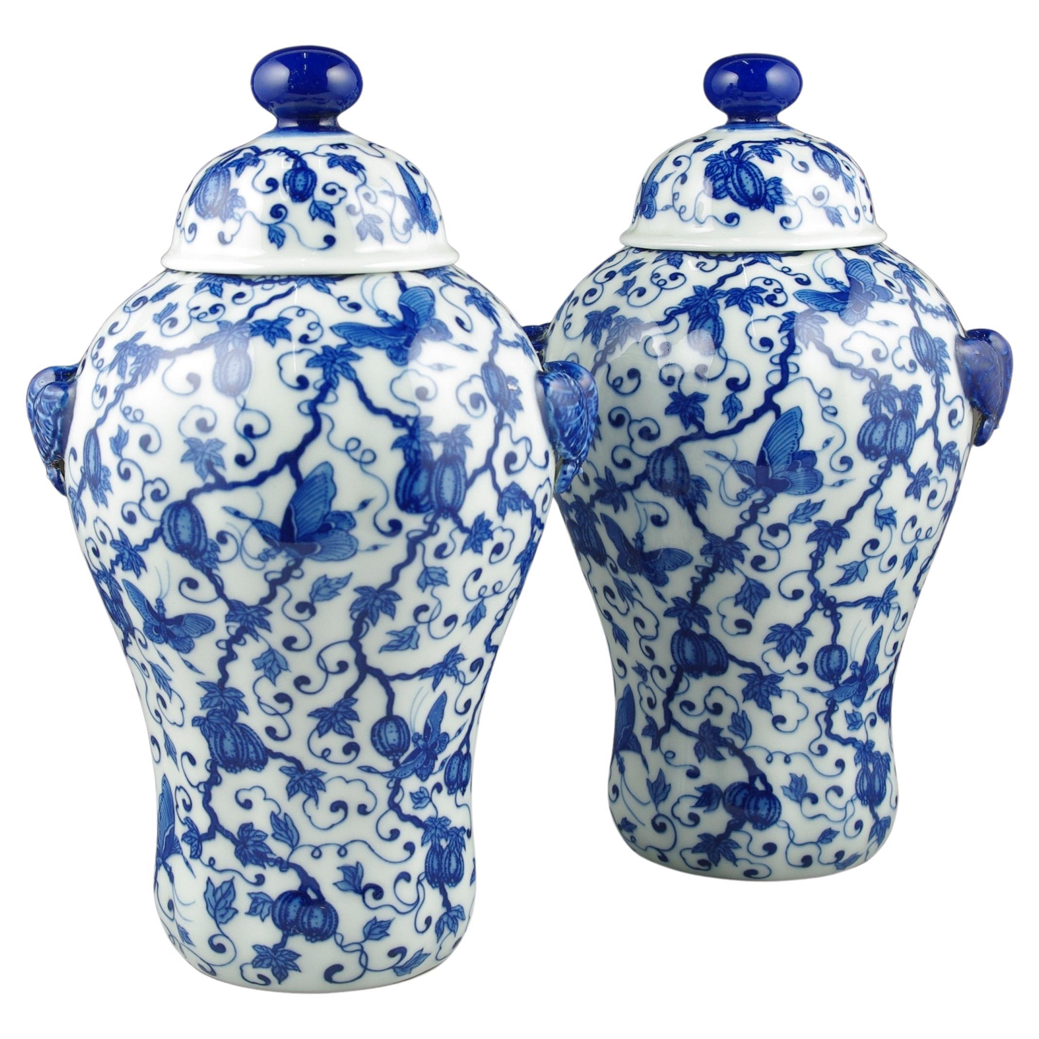 An exquisite pair of early 20th-century blue and white covered lobed baluster vases, a true embodiment of the artistic brilliance that characterizes this period in Chinese porcelain craftsmanship. Each vase, sculpted in a classic baluster form, is a