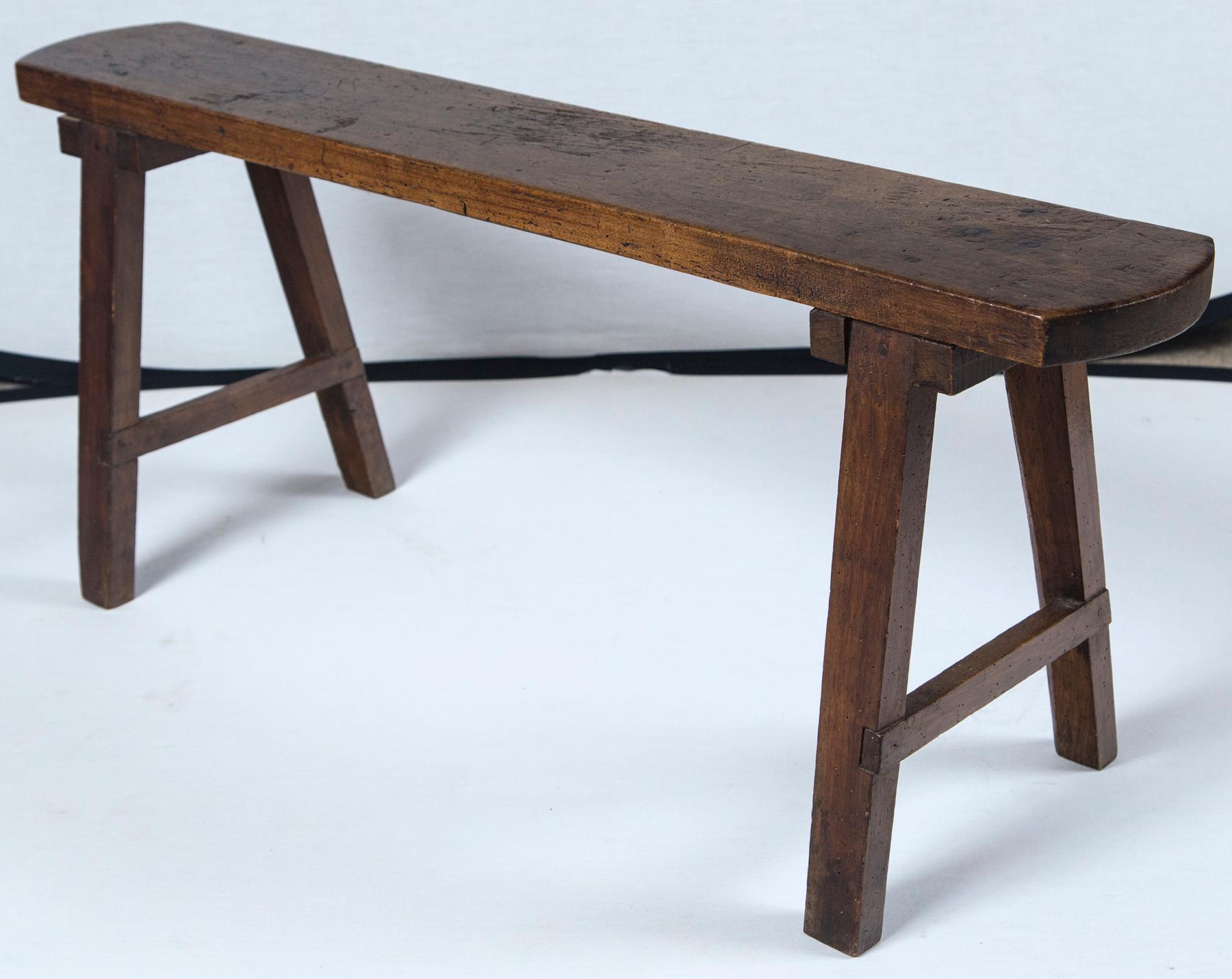 Pair of Chinese Provincial benches, circa 1900. Hardwood construction with rich, aged patina.