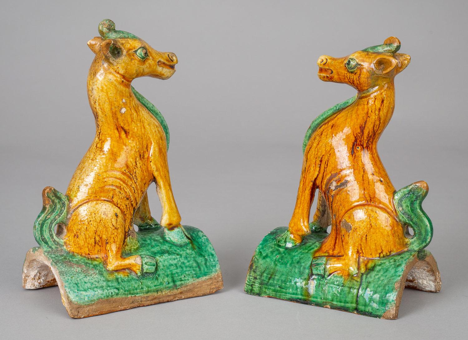 Charming pair of Chinese Qing dynasty Guangxu period pottery roof tiles in the form of horses sitting on their haunches with straight front legs, decorated in sancai colors of gold and green.