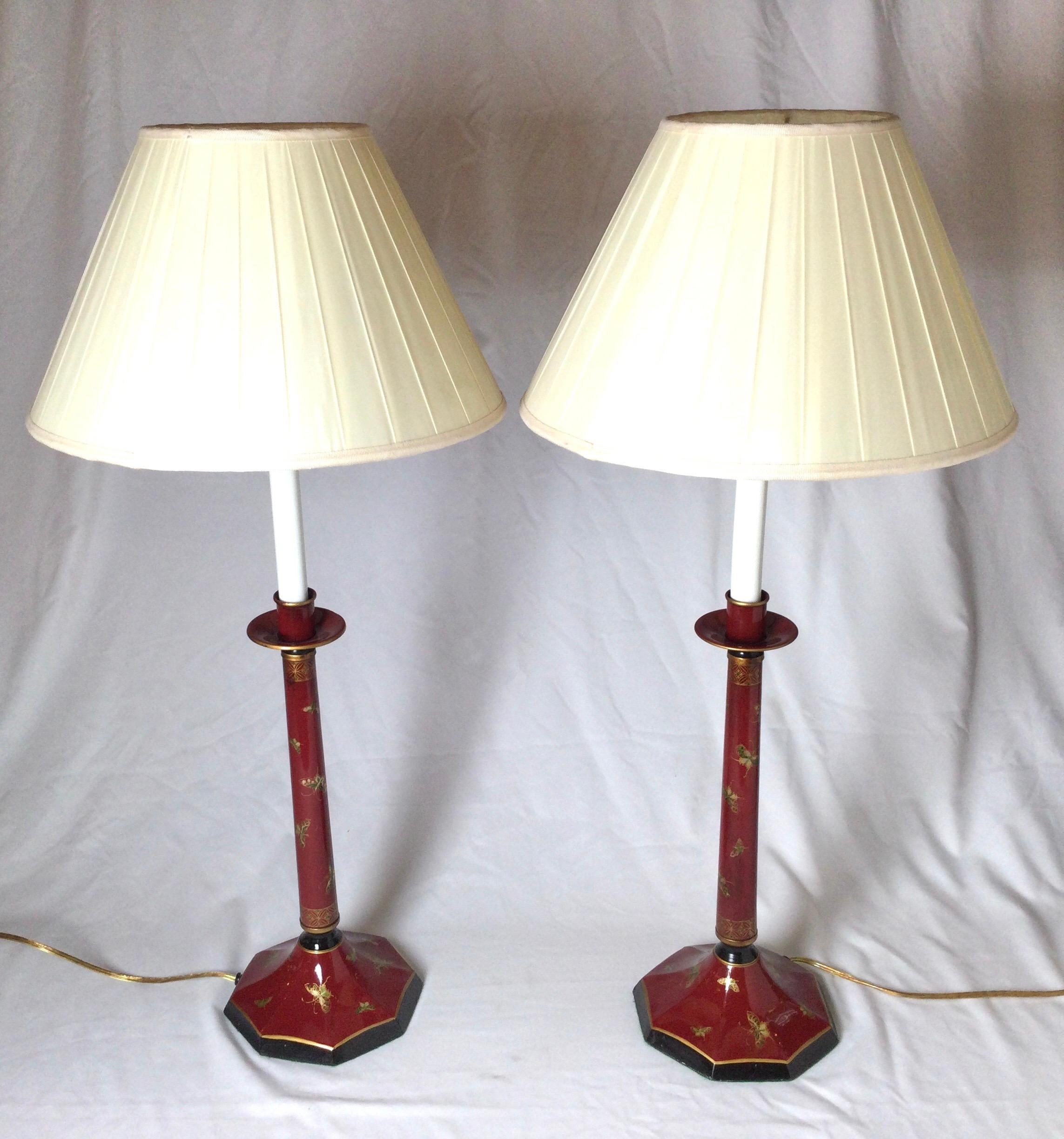 Pair of Chinese red with butterfly tole candlestick buffet lamps by Arrowsmith. 27” to top of finials 23.5 to top of socket 6.25” in diameter. Shades for photo only.