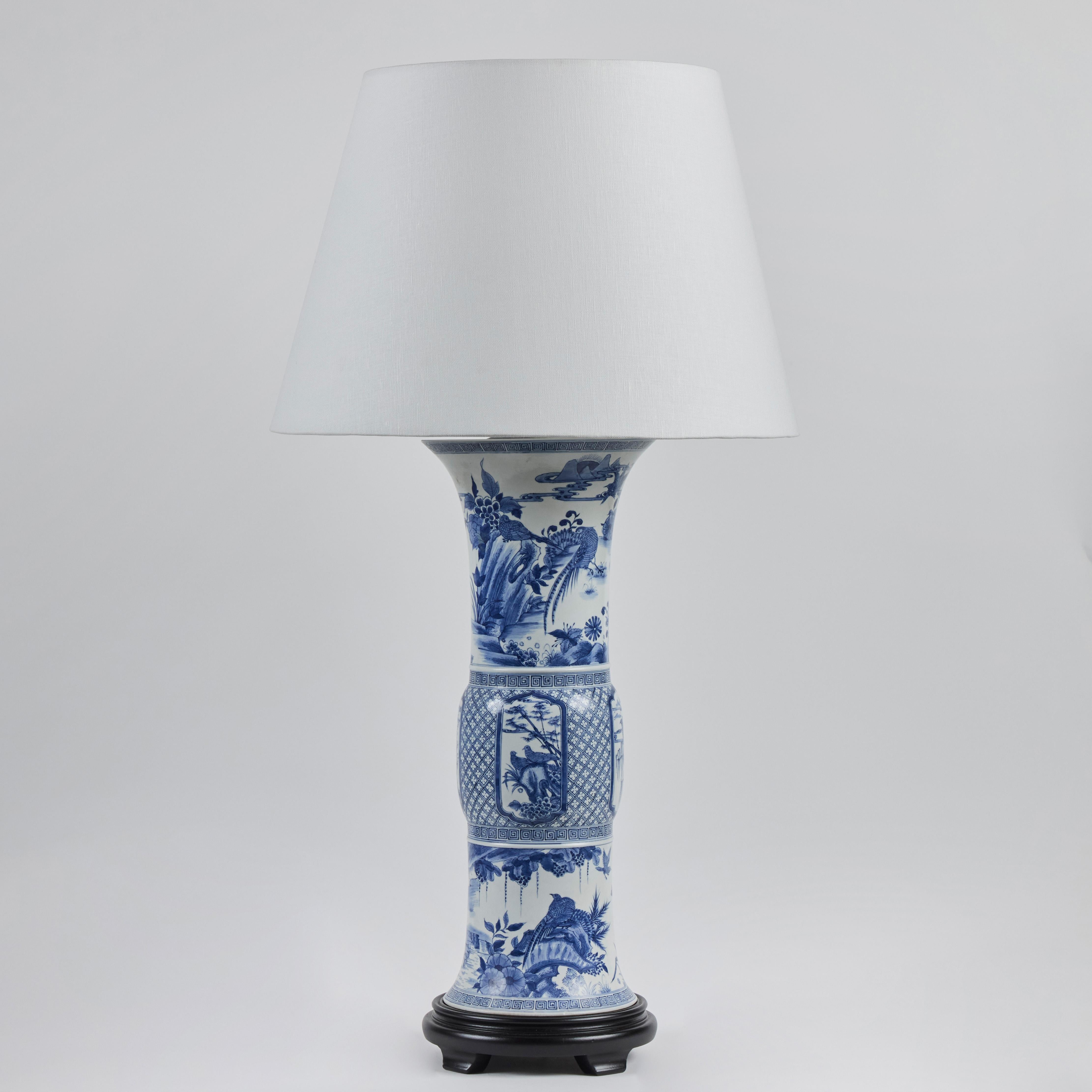 Pair of hand-painted porcelain Republic period Zun-form vases with matte glaze, made into lamps at a later date, mounted on ebonized wood bases.  Vases 19