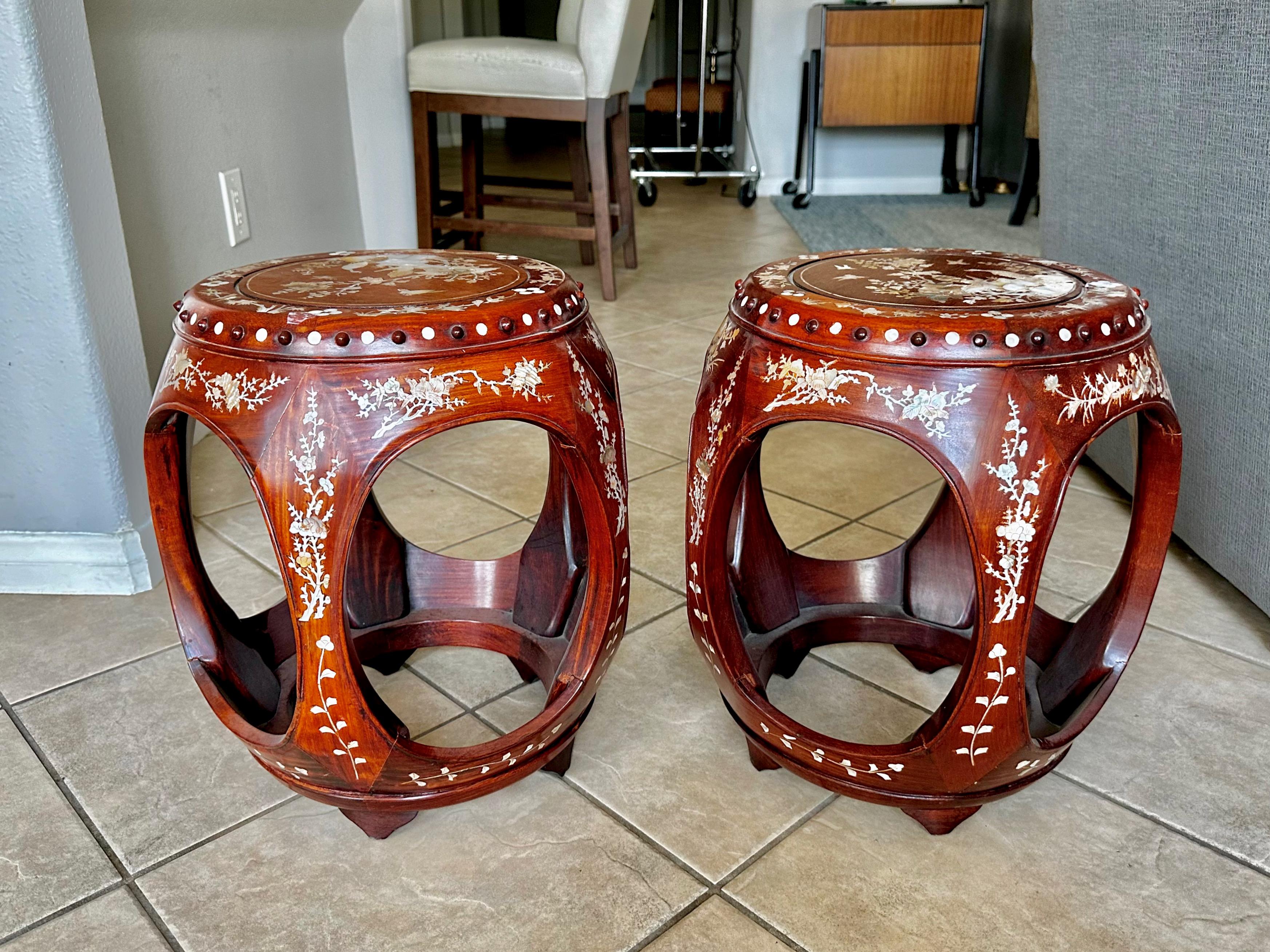 Pair of matching Chinese Asian carved beautiful rosewood barrel or garden stools covered in expertly crafted mother of pearl inlaid. 