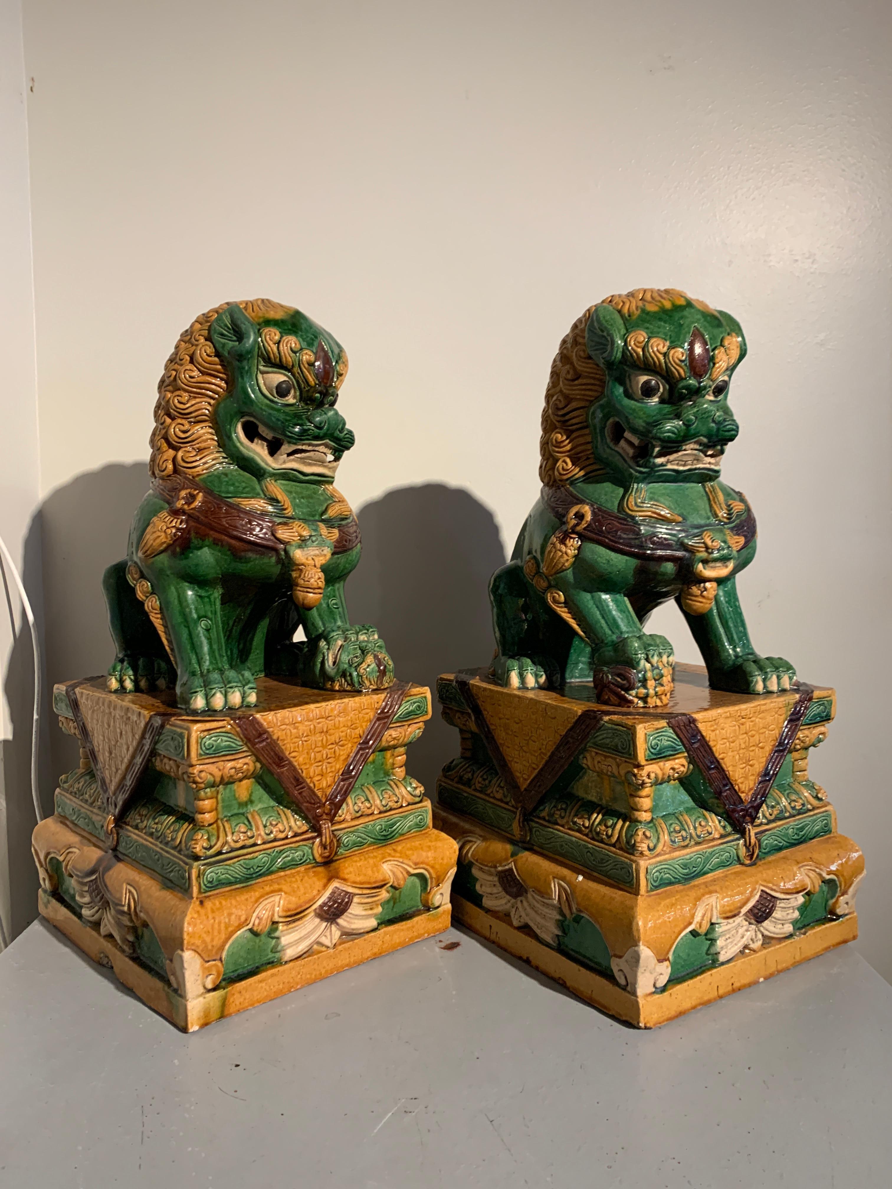 A fun and ferocious pair of Chinese sancai glazed guardian lions, mid 20th century, circa 1960s, China.

The fabulous foo lions are crafted in stoneware and glazed all over in a stunning sancai glaze of predominantly green and contrasting yellow,