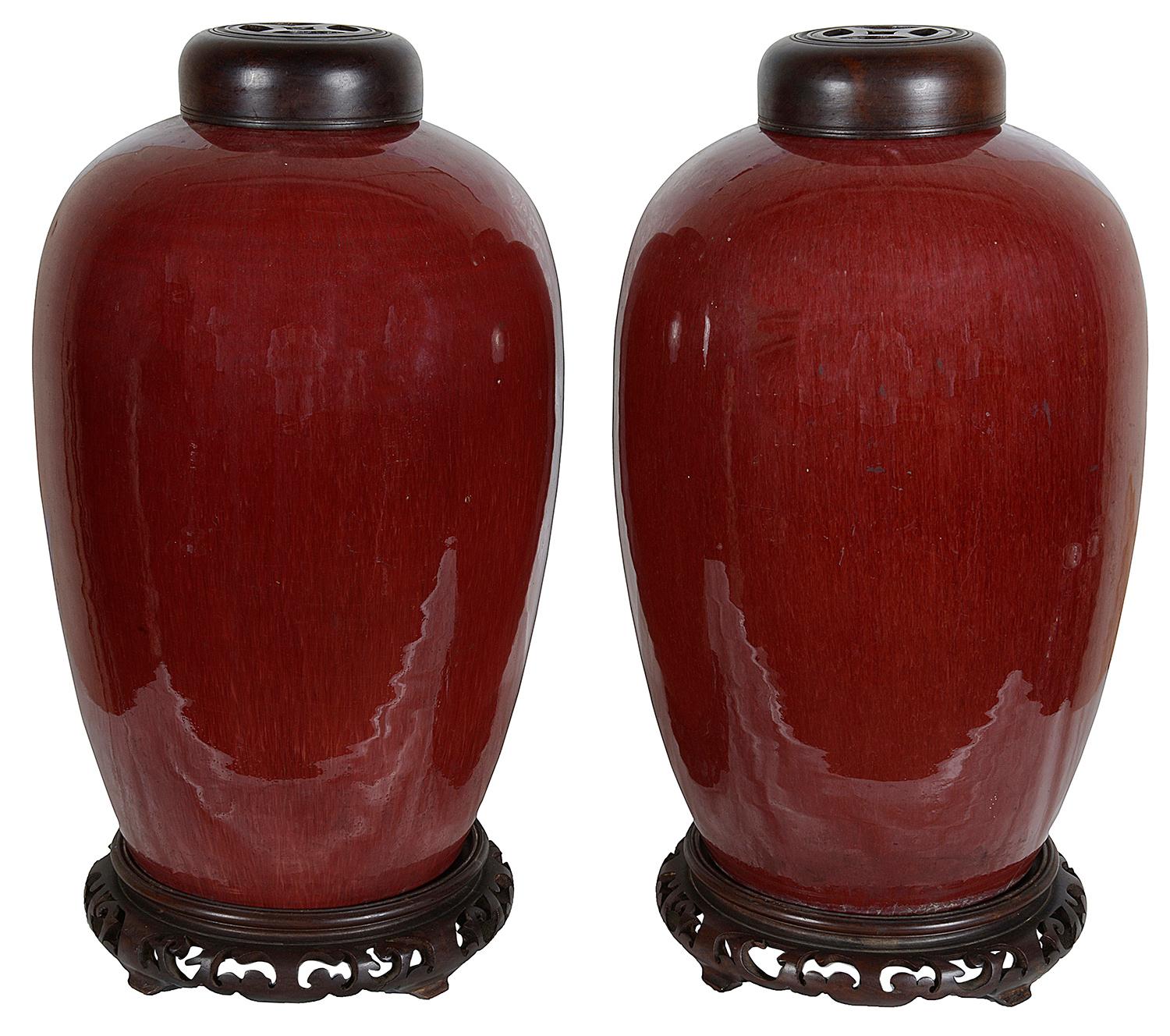 Hand-Painted Pair of Chinese Sang Du Bouf lidded vases, circa 1890