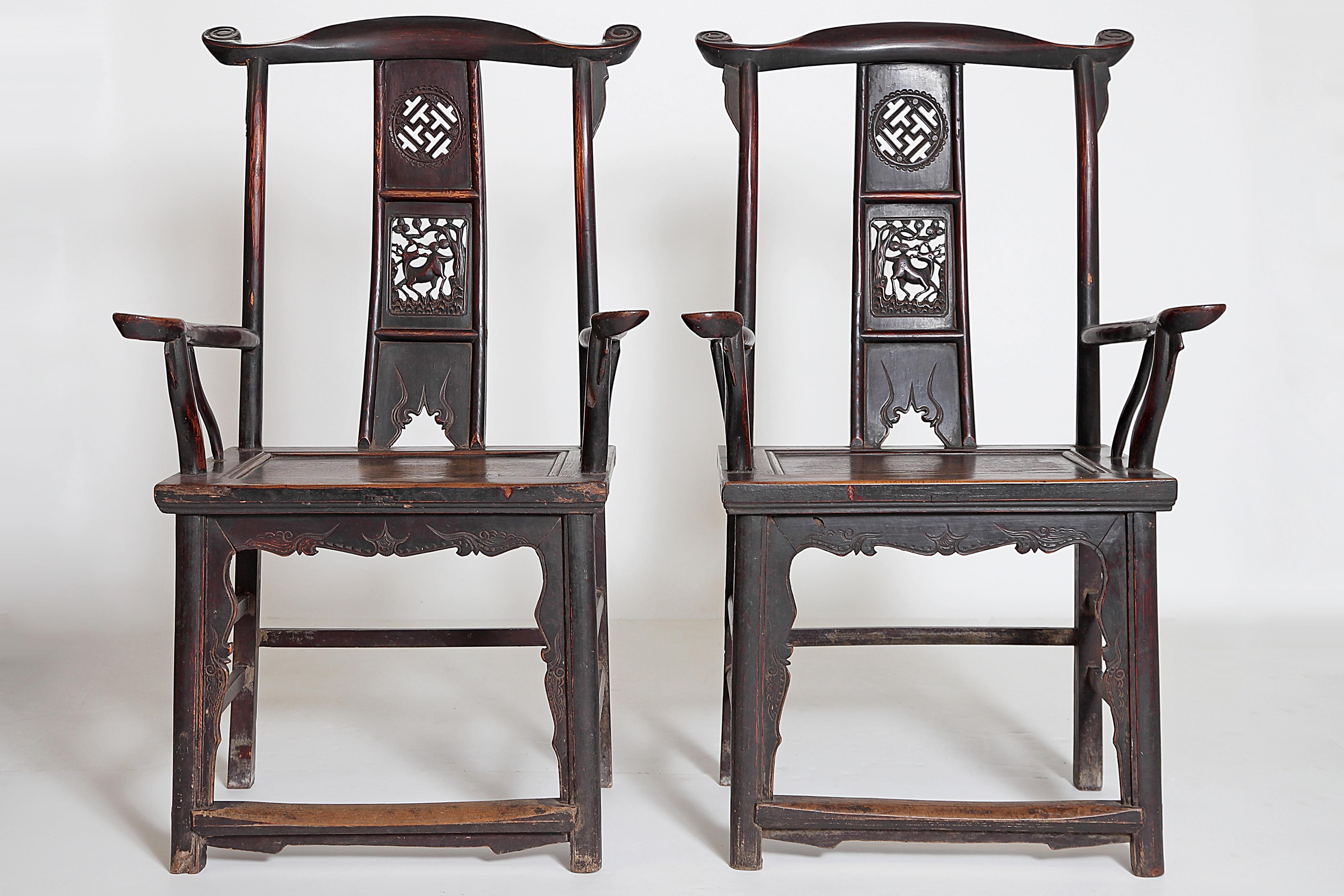 A pair of antique Chinese scholar's chairs, oak with nice patina, curved back a splat with open fretwork decorations, including a deer and various symbols, solid seats, nicely shaped arms, straight legs with stretchers, 19th century, China.