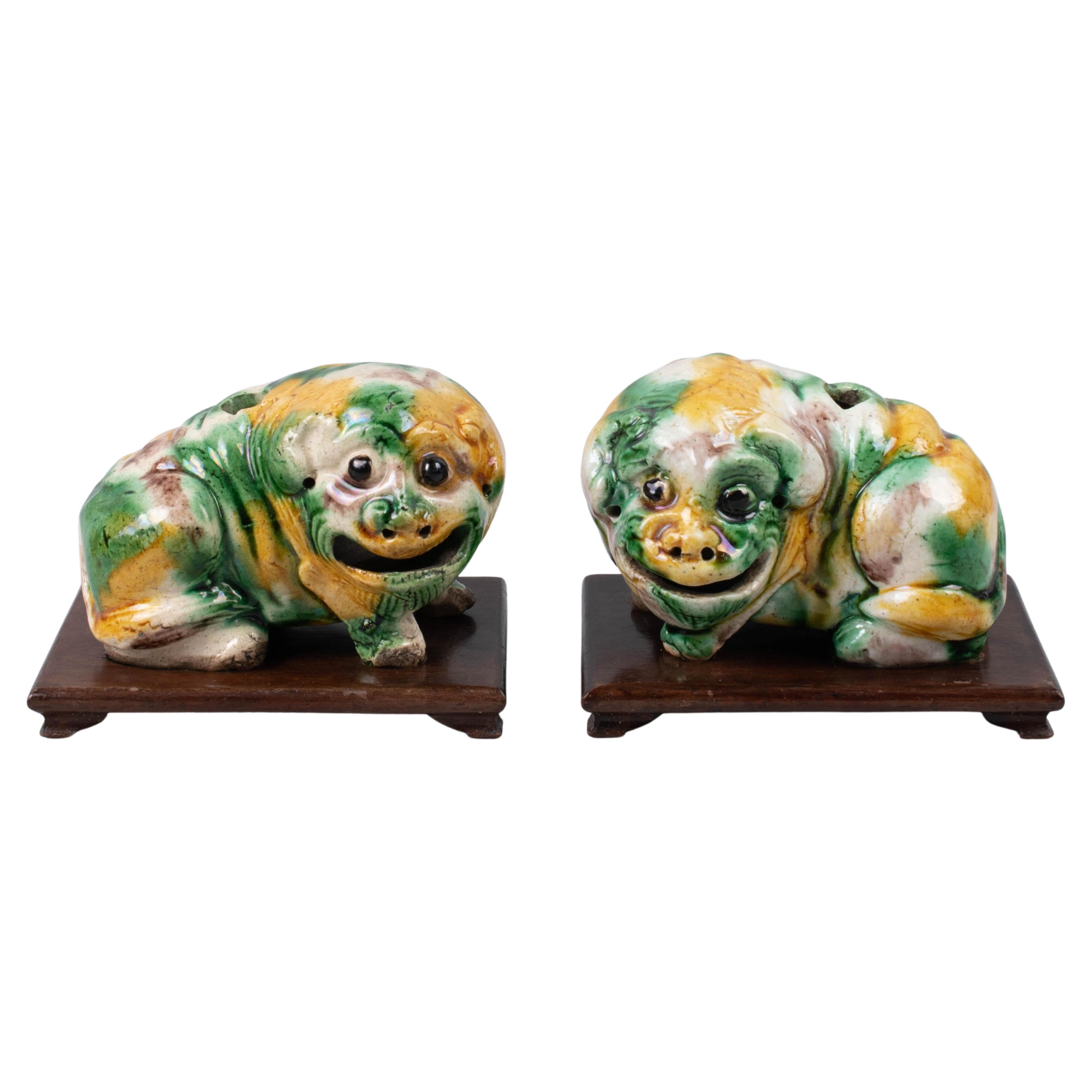 This pair of small Chinese Shar Pei puppies was made in the mid-19th century, circa 1860.                
They are charming creatures with adorable faces. 
They are decorated with traditional Sancai three-color yellow, purple, and green glazes.
