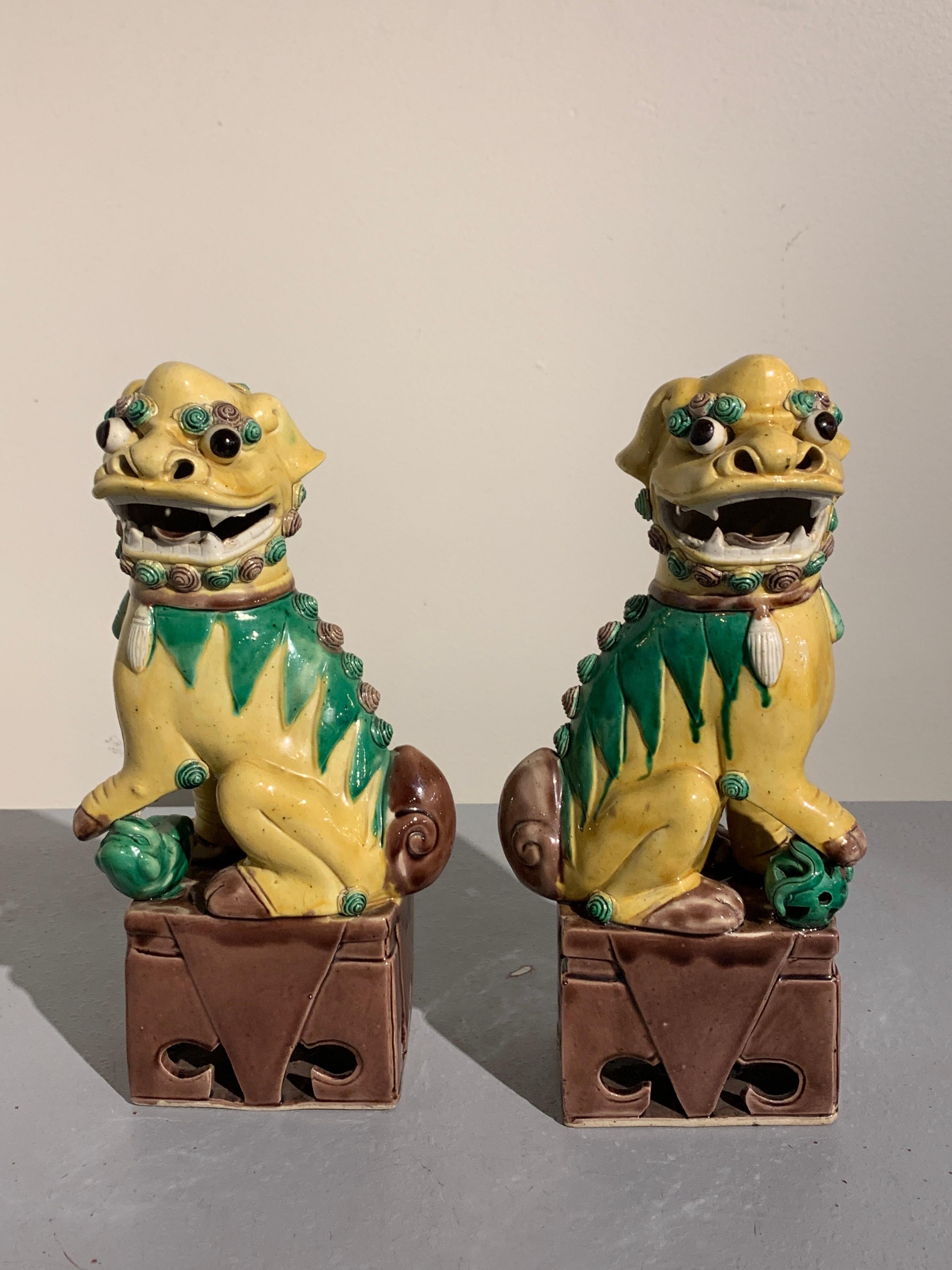 Mid-20th Century Pair of Chinese Yellow Glazed Porcelain Foo Dogs, circa 1930s