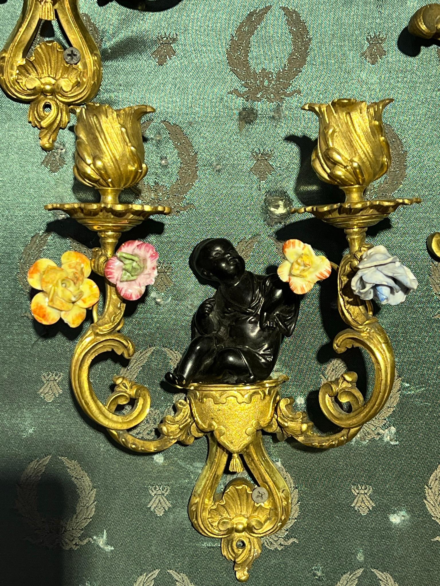 Pair of very fine quality and unusual 19 century French Chinoiserie Gilt Bronze and Porcelain Sconces with Buddha motif.