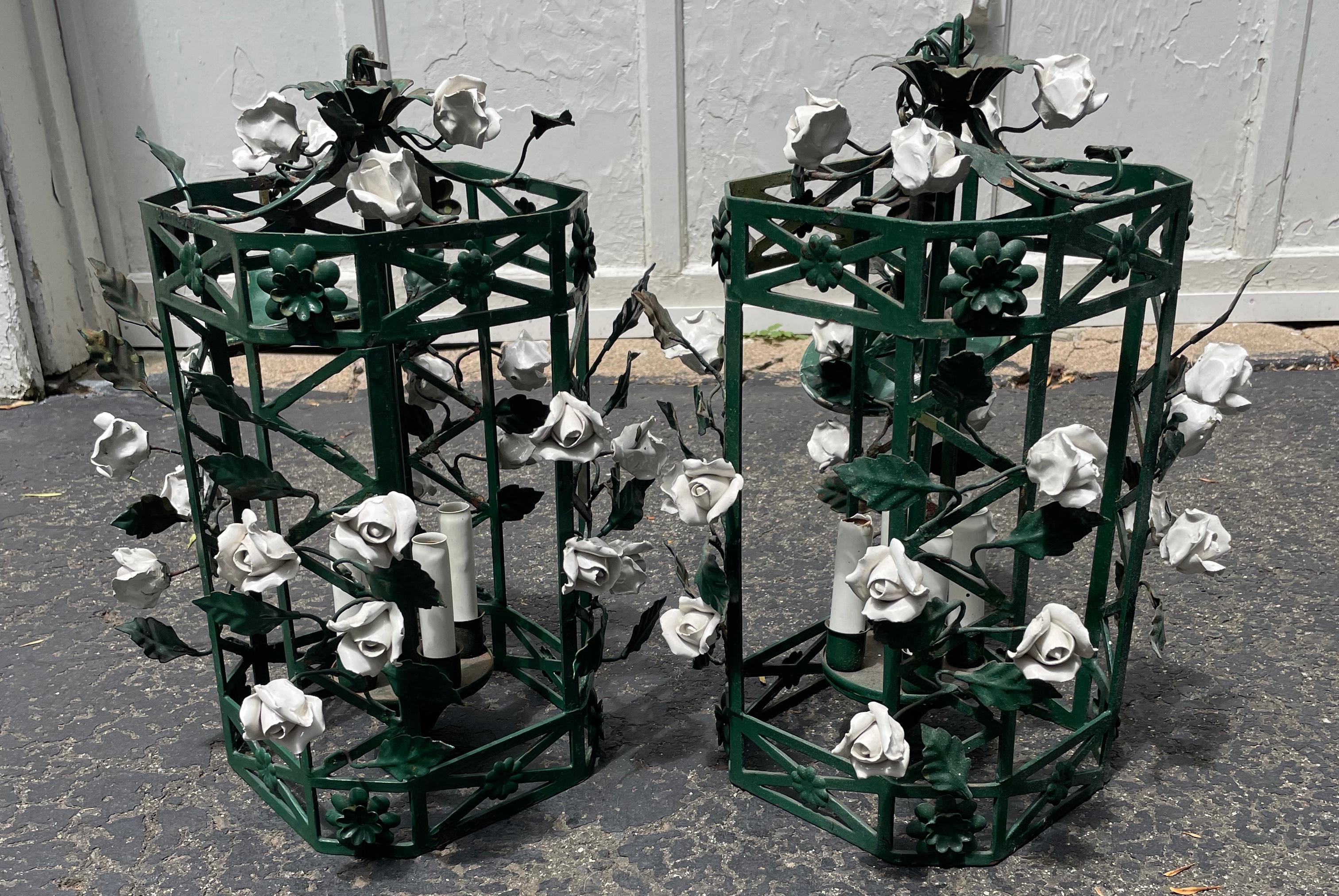 Pair chinoiserie green lanterns with white porcelain flowers. Pair chinoiserie style green painted metal octagonal trellis form lanterns, with climbing white porcelain flowers and green metal leaves with four lights. Perfect for your large summer