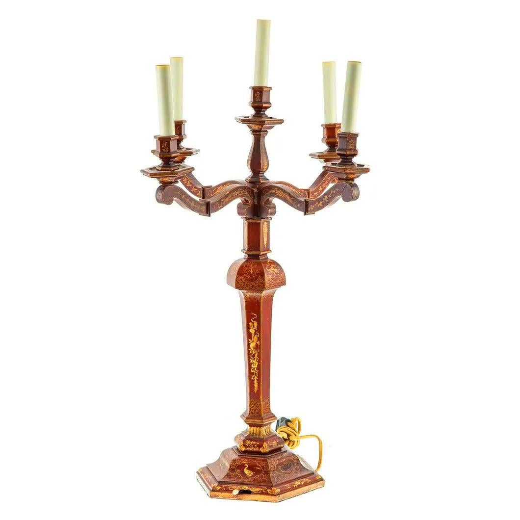 Our beautiful pair of candelabra in the Chinoiserie style date from the early 20th century, and feature four candle arms with candelabra-size sockets, and fine red japanned surfaces with hand-painted gilt designs. Each with old cloth-sheathed wiring