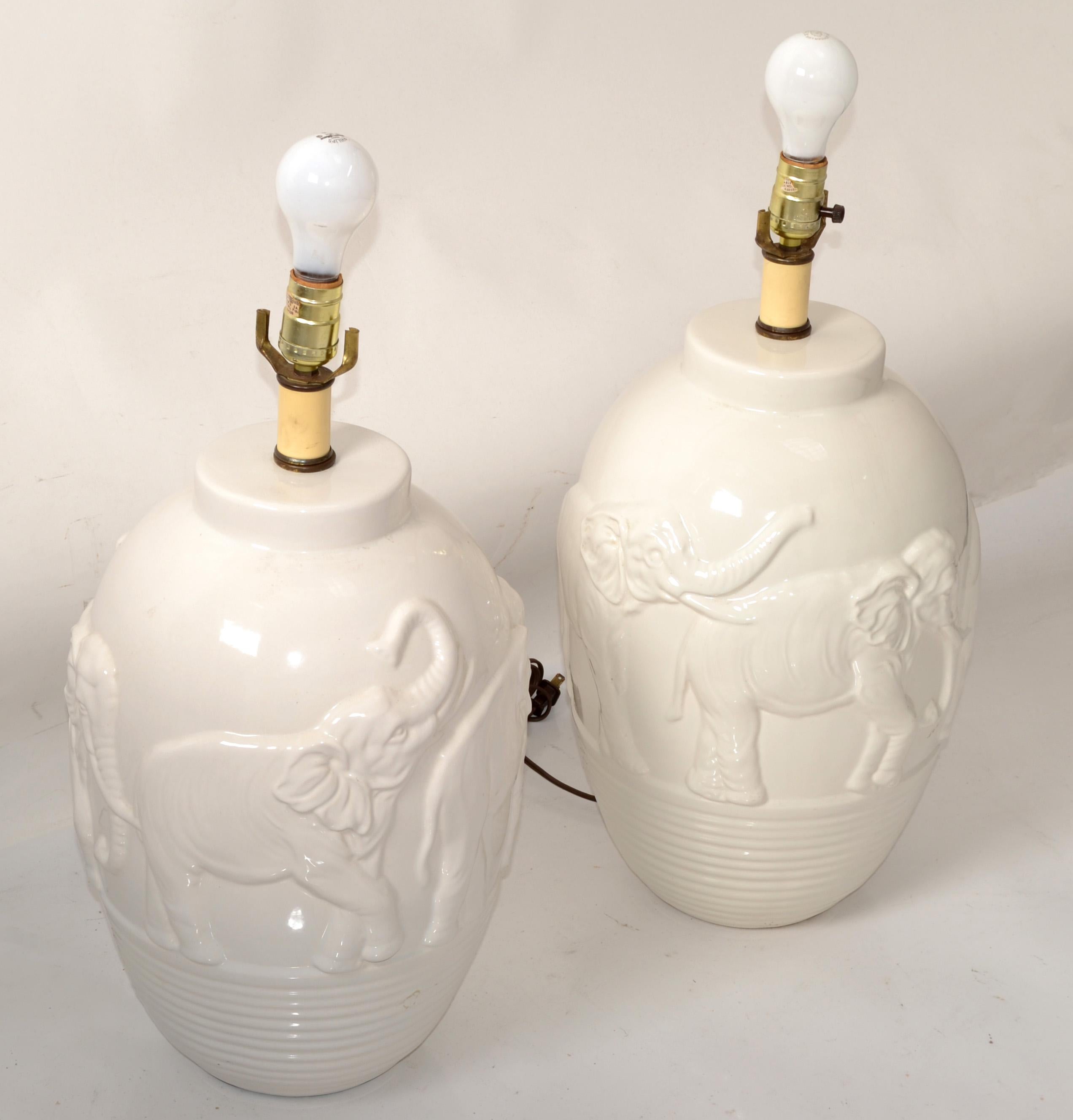 Asian Chinoiserie Style Pair of Off-White vintage glazed ceramic Table Lamps with Elephant 2D Motives and deeply incised base.
UL Listed, each Lamp takes a regular or LED Light bulb.
No Harp, Finial, Shade.
Great Lamps for the Master Bedroom, on Top