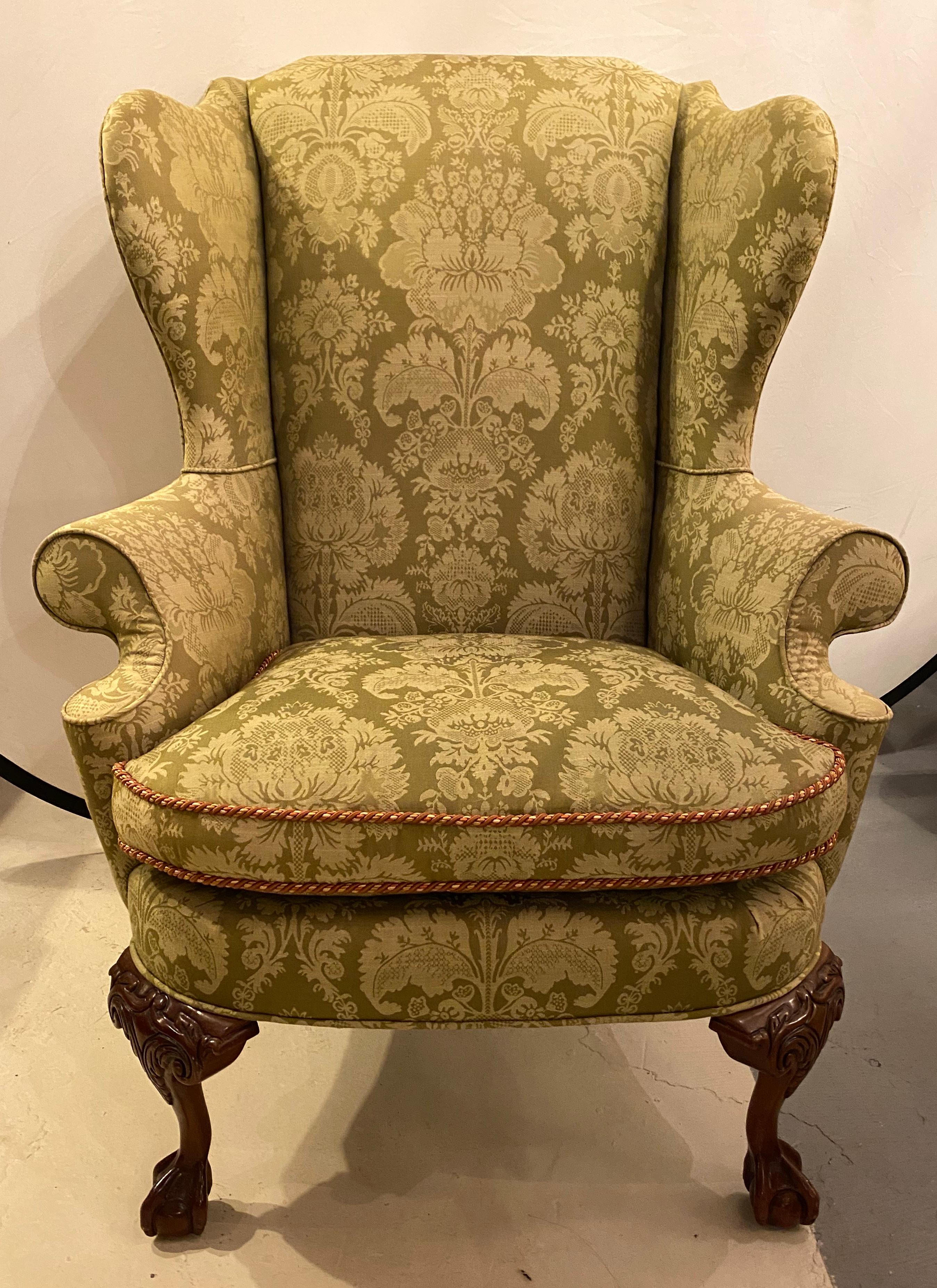 Pair of Chippendale ball and claw wingback chairs with fine scalamandre upholstery. These incredibly upholstered arm, lounge or wingback chairs are simply stunning. The high back style and flair of the Chippendale era come alive in these hard to