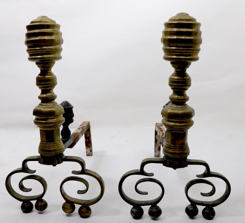 Stylish pair of brass andirons, early 20th century Chippendale style andirons. Overall very good condition, showing minor wear, normal and consistent with age and use.