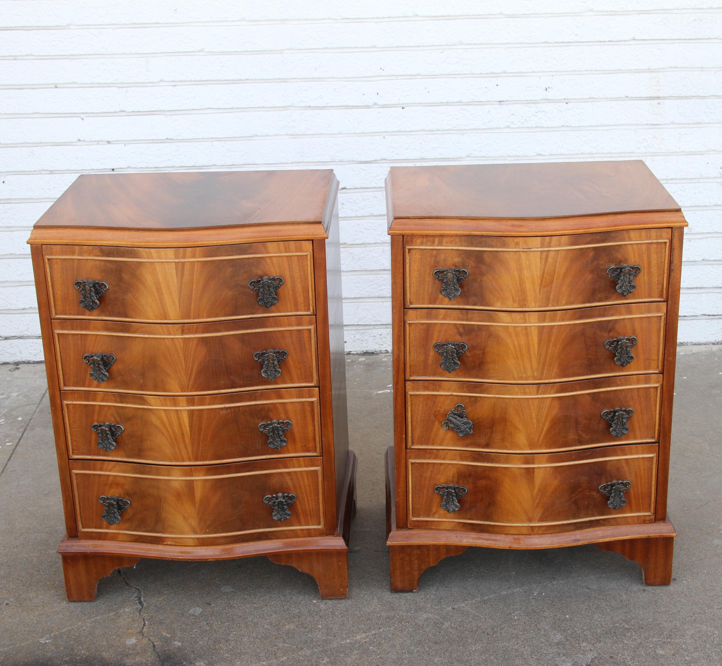 Pair English Chippendale Style Nightstands or Lamp Tables

Four drawer nightstands in a burr walnut.
Bow front with beautiful grain. Ornate bronze pulls.



