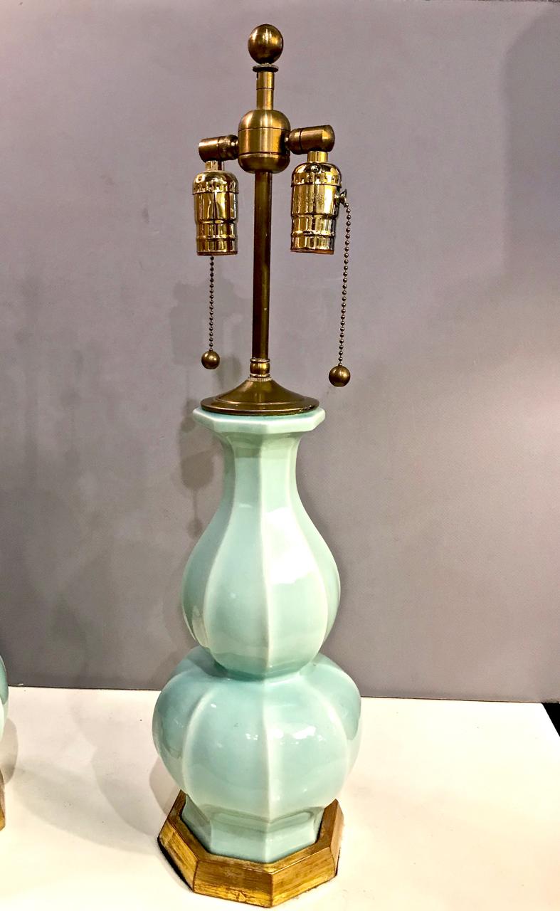 This is a superb pair of early Christoper Spitzmiller lamps in a soft aqua glaze and gold leafed bases.
The lamps are in excellent condition and are each signed and dated May 2003 on both bottoms.