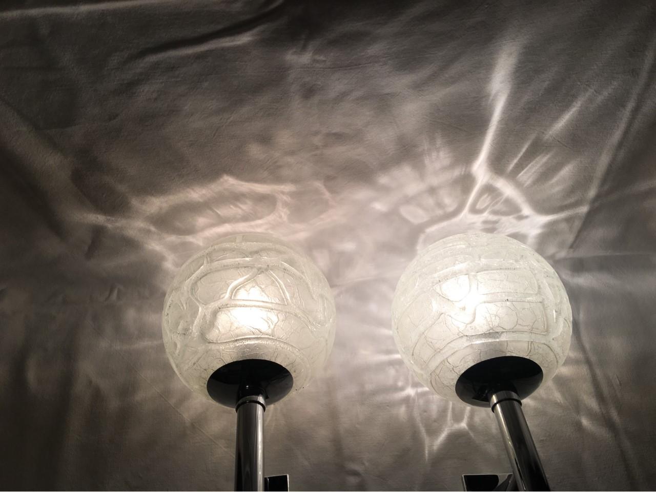 A nice pair of structured glass wall lamps with chrome brackets from the 1960s. Manufactured by the renowned German Company Doria Leuchten Each fixture requires one European E 14 candelabra bulb, each bulb up to 40 watts. Rewired to meet U.S.