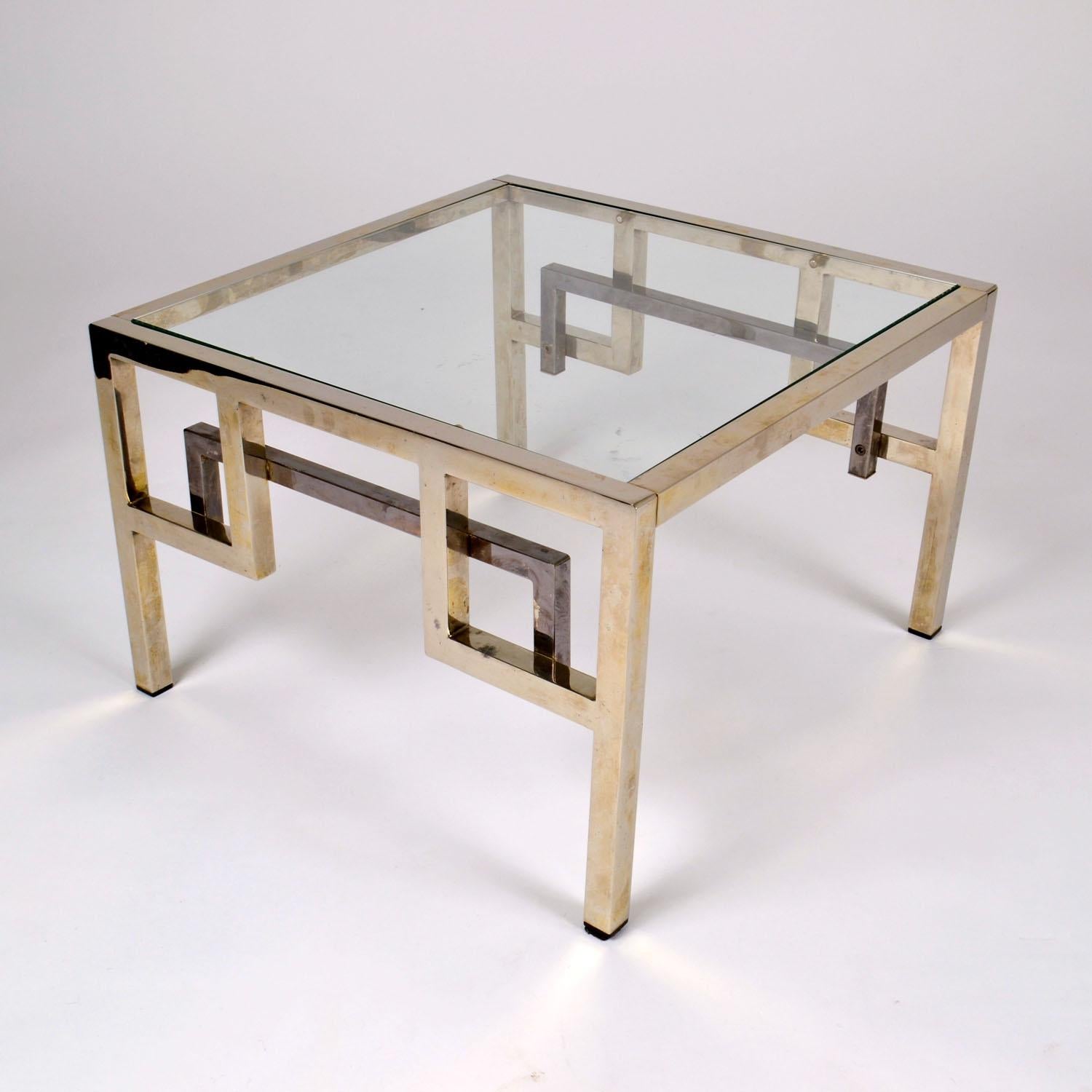 Pair of square Belgo Chrome coffee tables, Belgium circa 1970. The angular framed in alternating polished chrome and lightly oxidized brass and a glass rests on top. 
