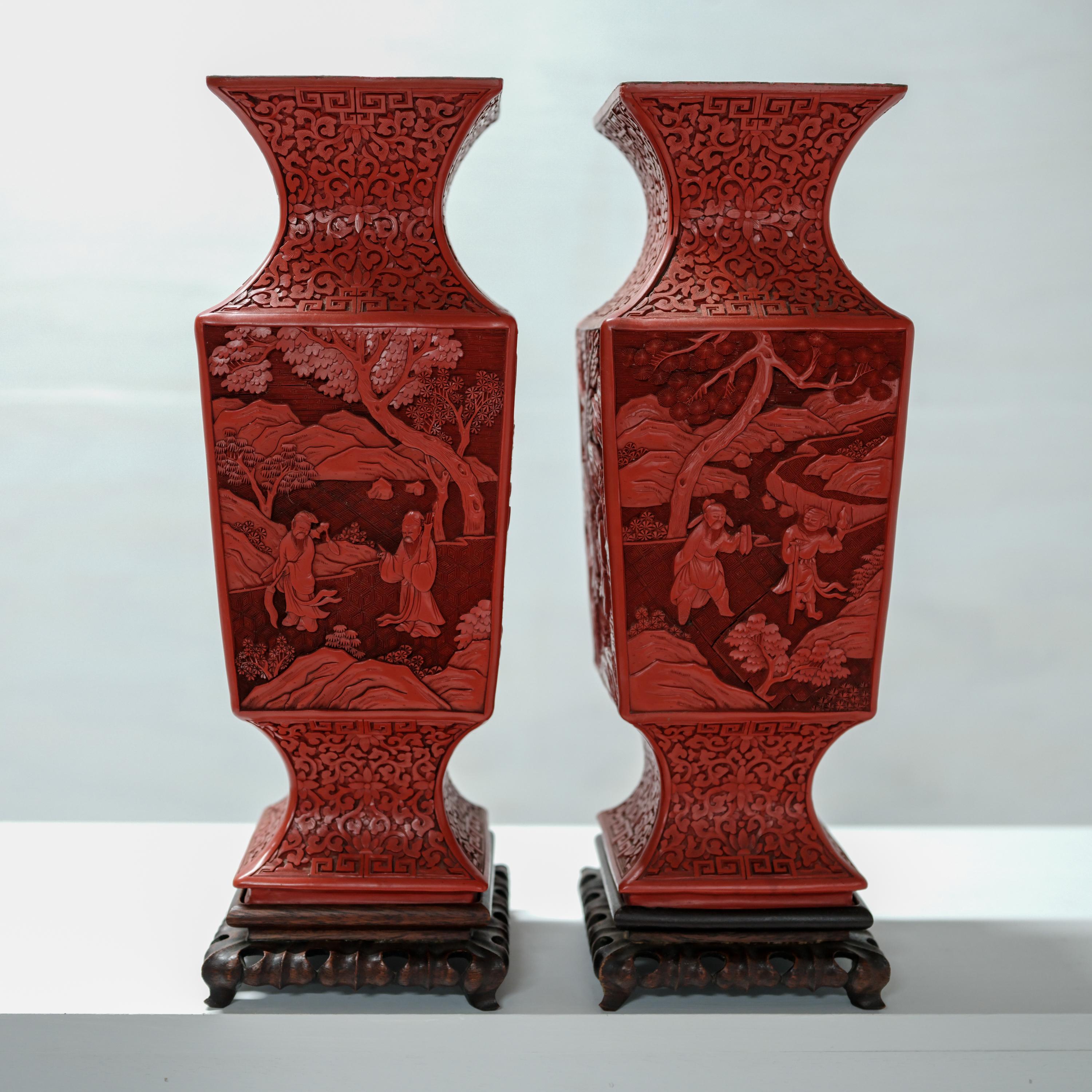 A gorgeous pair of late 19th century carved cinnabar urns with their original hand-carved rosewood stands. The 17