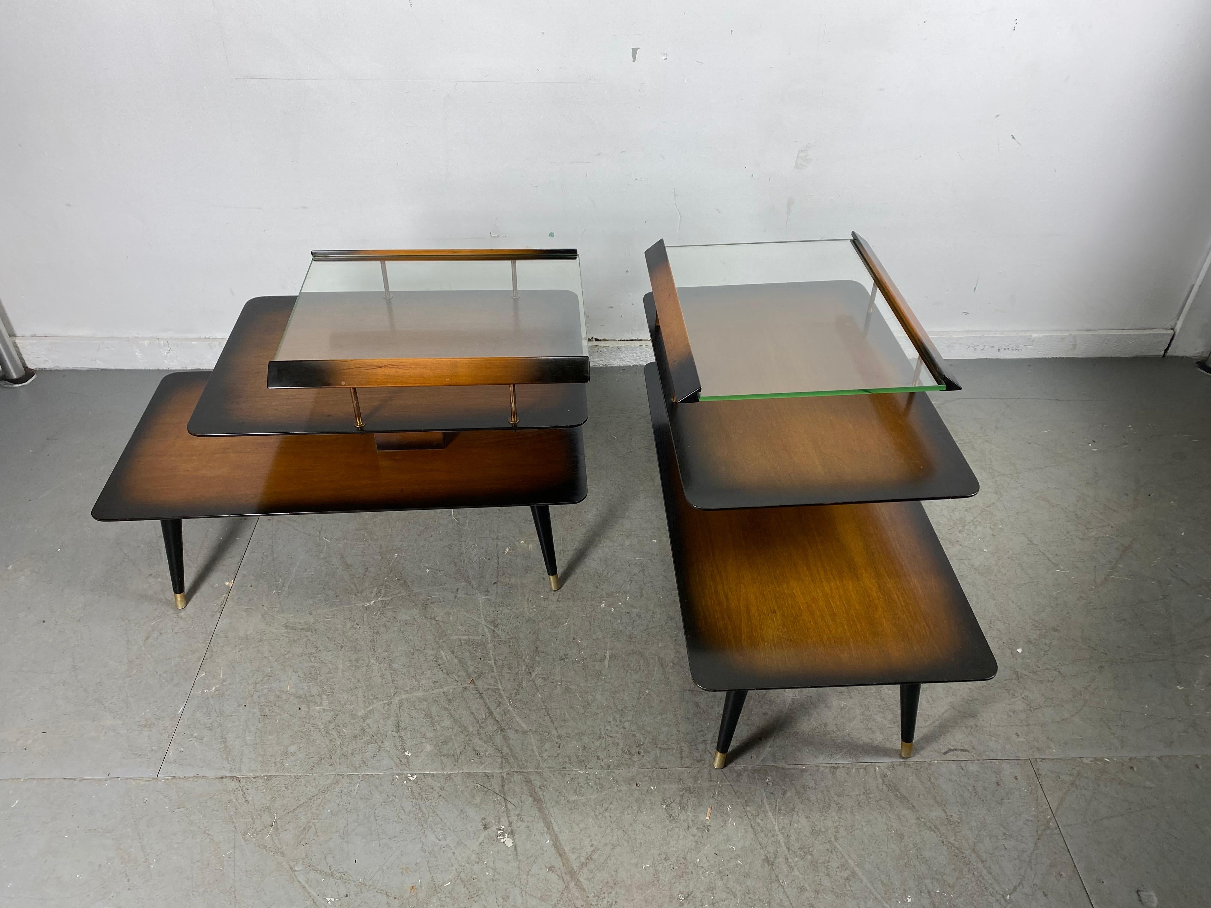 Pair Classic Mid-Century Modern end tables by James Philip Co., unusual tables. Architectural design, 3-tier construction, retain original early green edge glass tops, minor wood damage to top edge (see photo). Also retains original label.