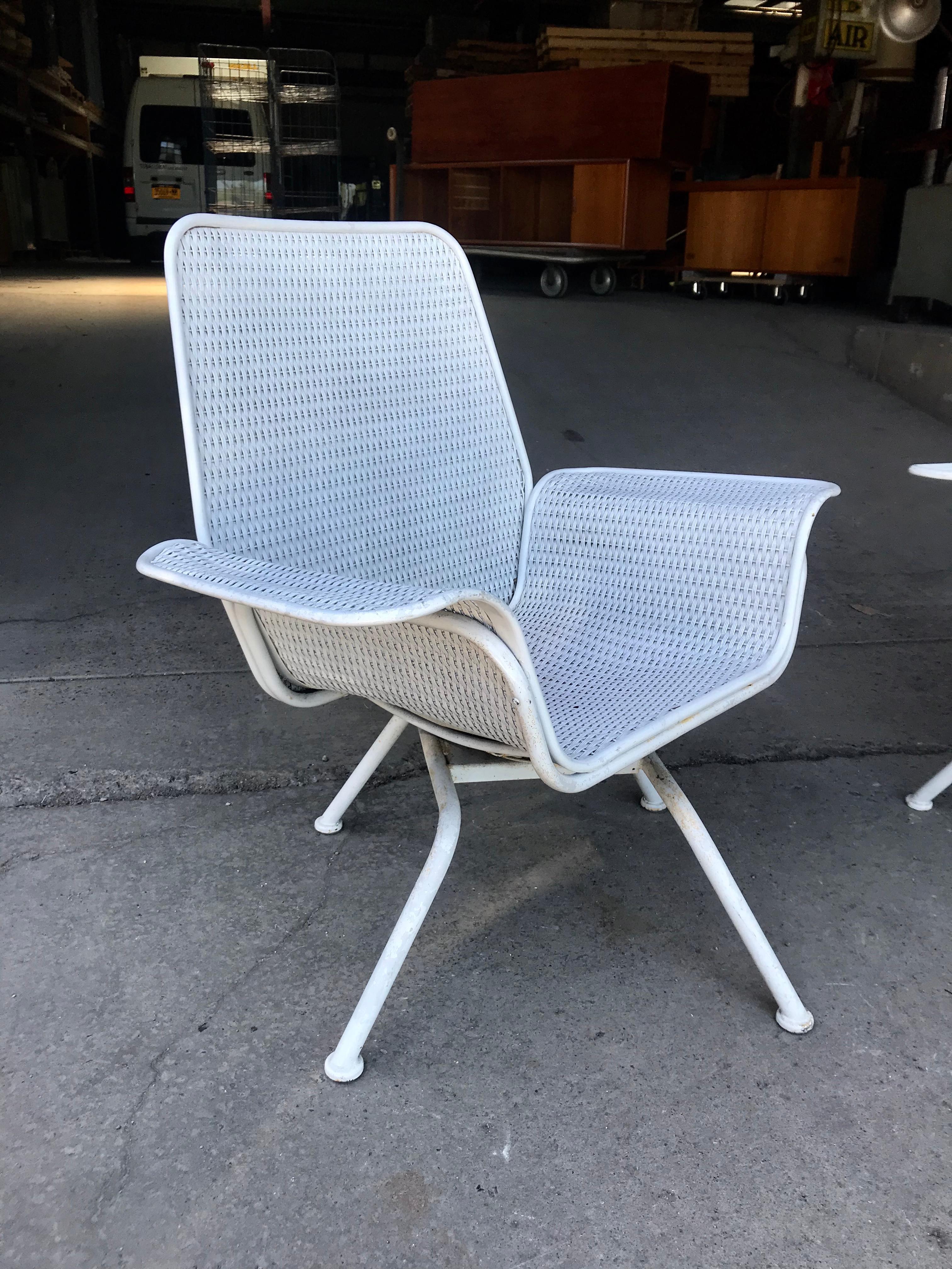 Pair of classic Mid-Century Modern swivel wicker and metal outdoor lounge chairs. Amazing design, reminiscent of George Nelsons 