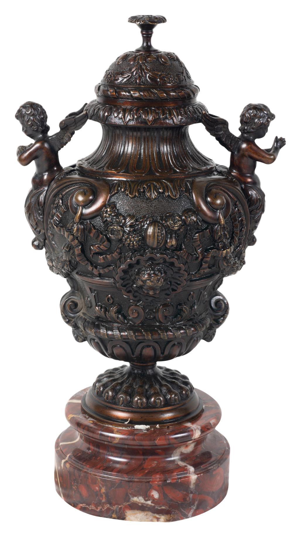 A very good quality pair of classical 19th century bronze lidded vases, each with cherub handles, floral, swag and ribbon decoration and raised on rouge marble bases.