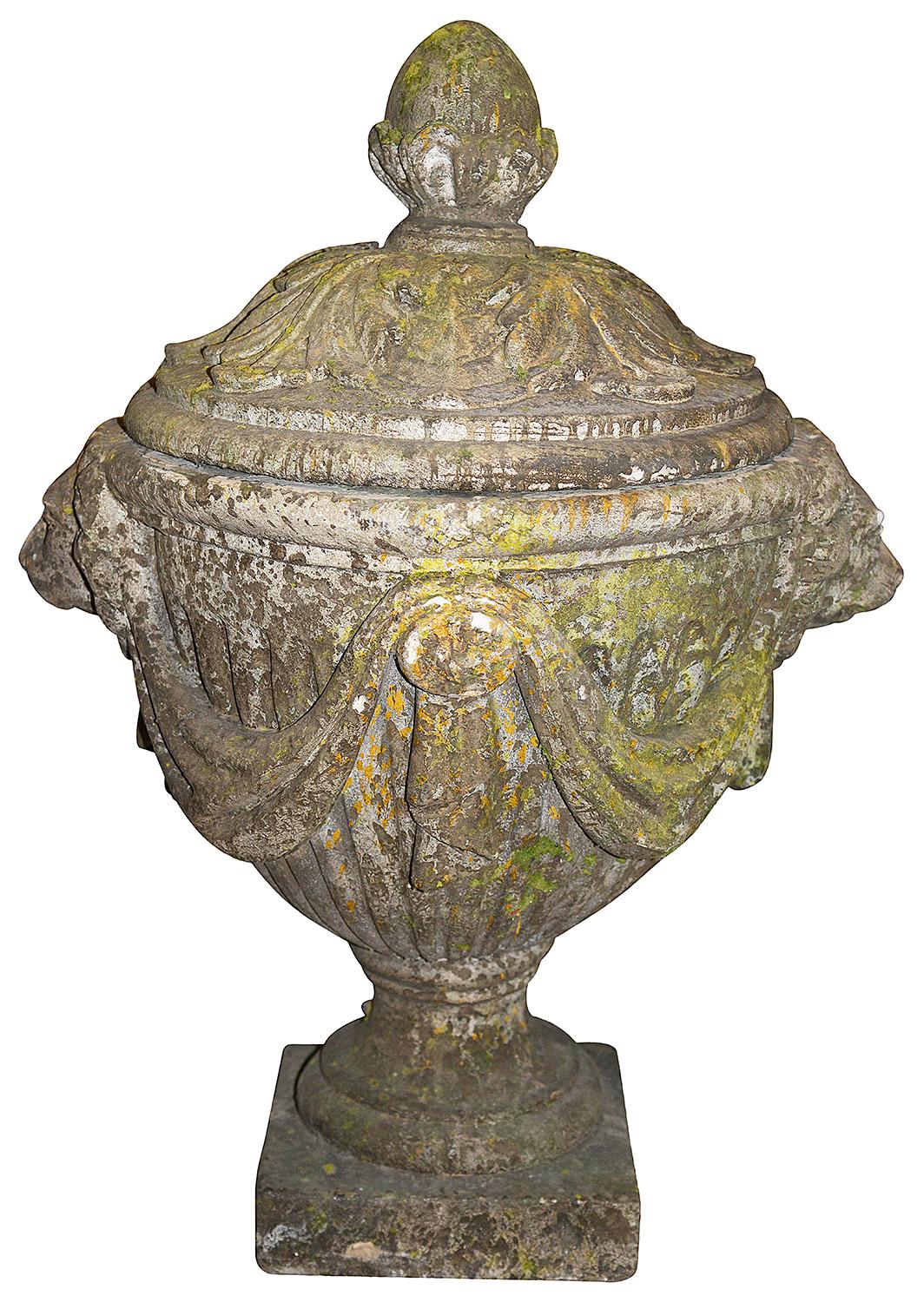 A very impressive pair of classical 19th century lidded garden urns, each with acorn finials, scrolling foliate relief to the lids, fluted decoration with Lion mask handles, draped ribbon swags and raised on pedestal bases.