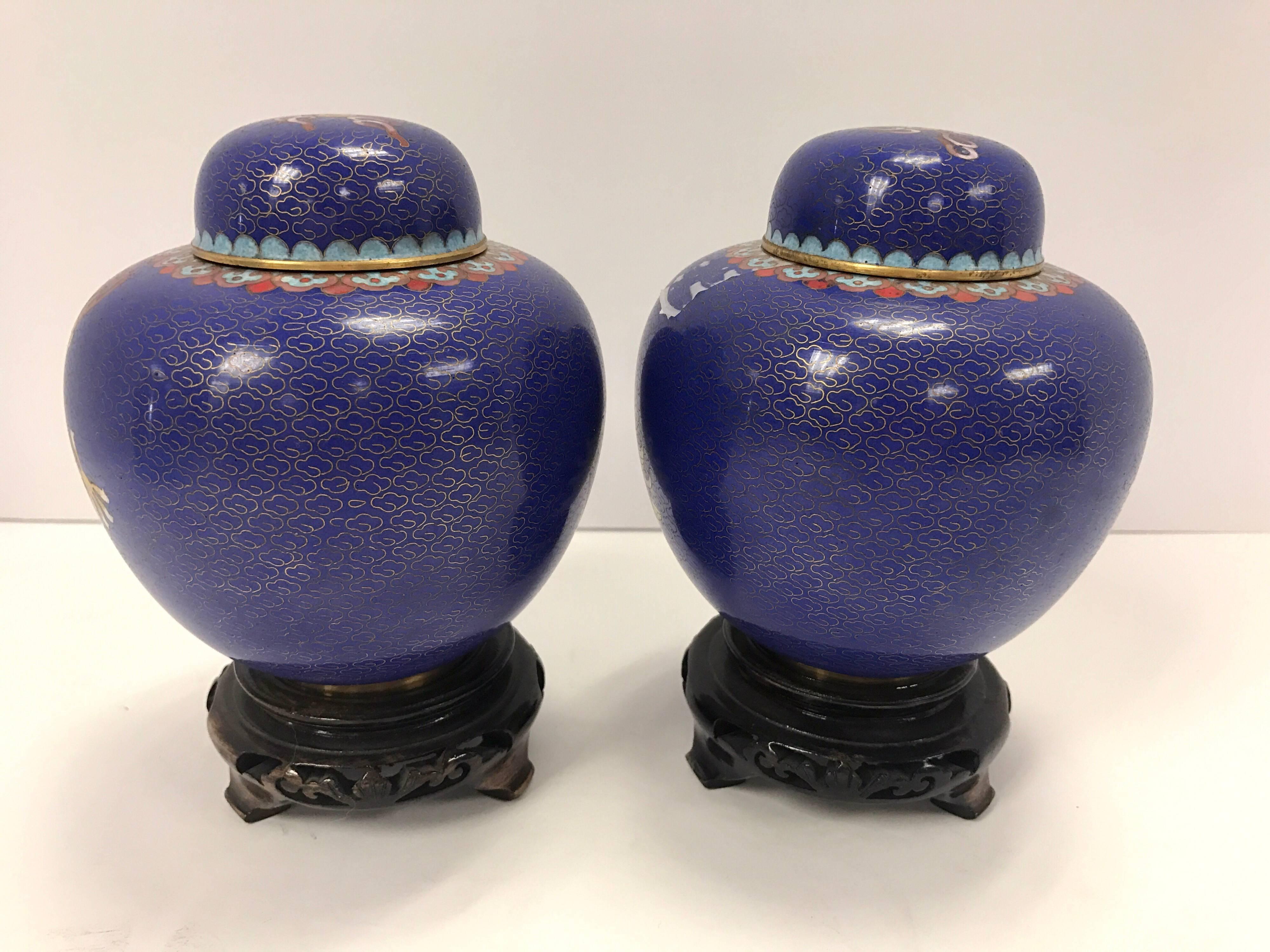 Stunning cloisonné dragon ginger jars with carved wooden stands..